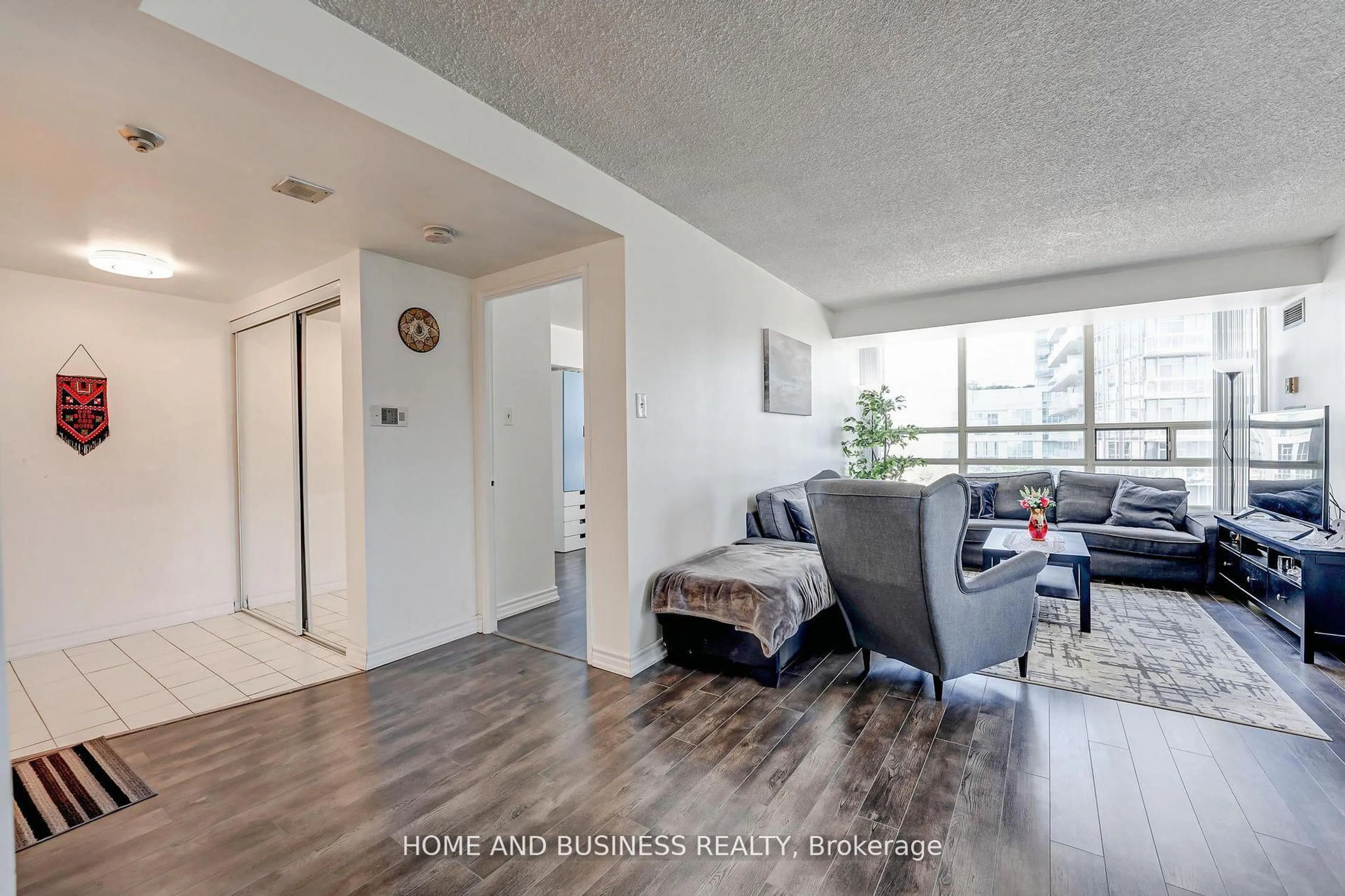 Living room with furniture, wood/laminate floor for 250 Webb Dr #1015, Mississauga Ontario L5B 3Z4