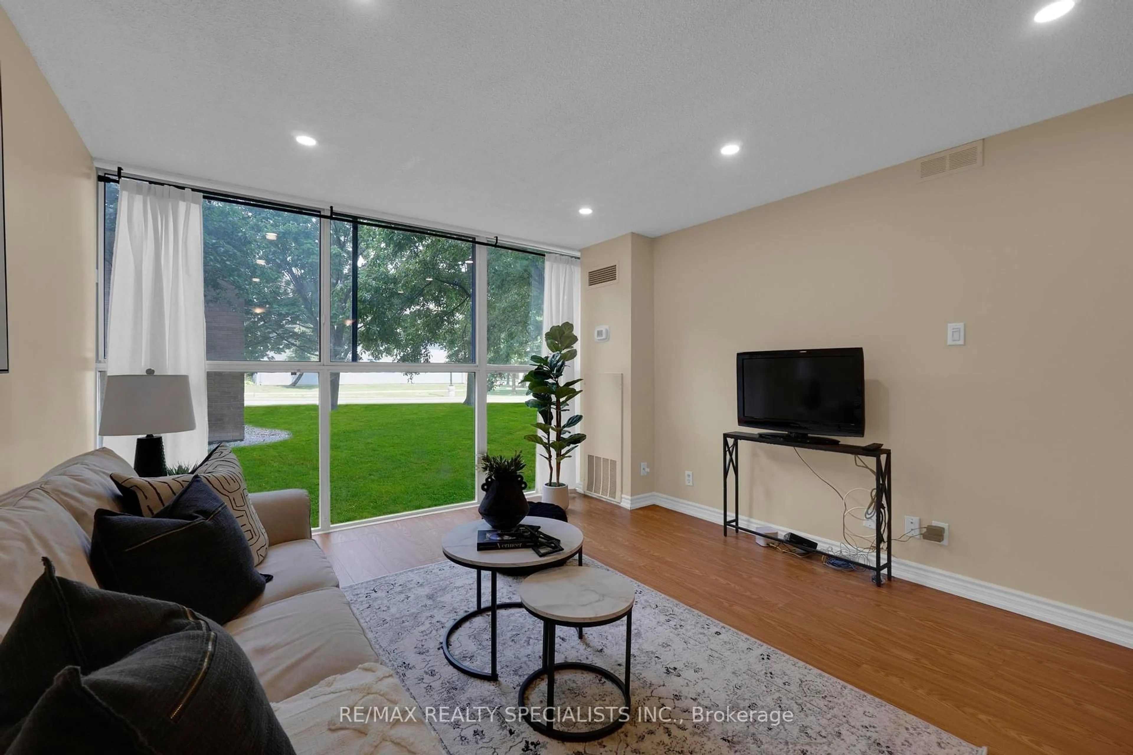 Living room with furniture, unknown for 35 Trailwood Dr #113, Mississauga Ontario L4Z 3L6