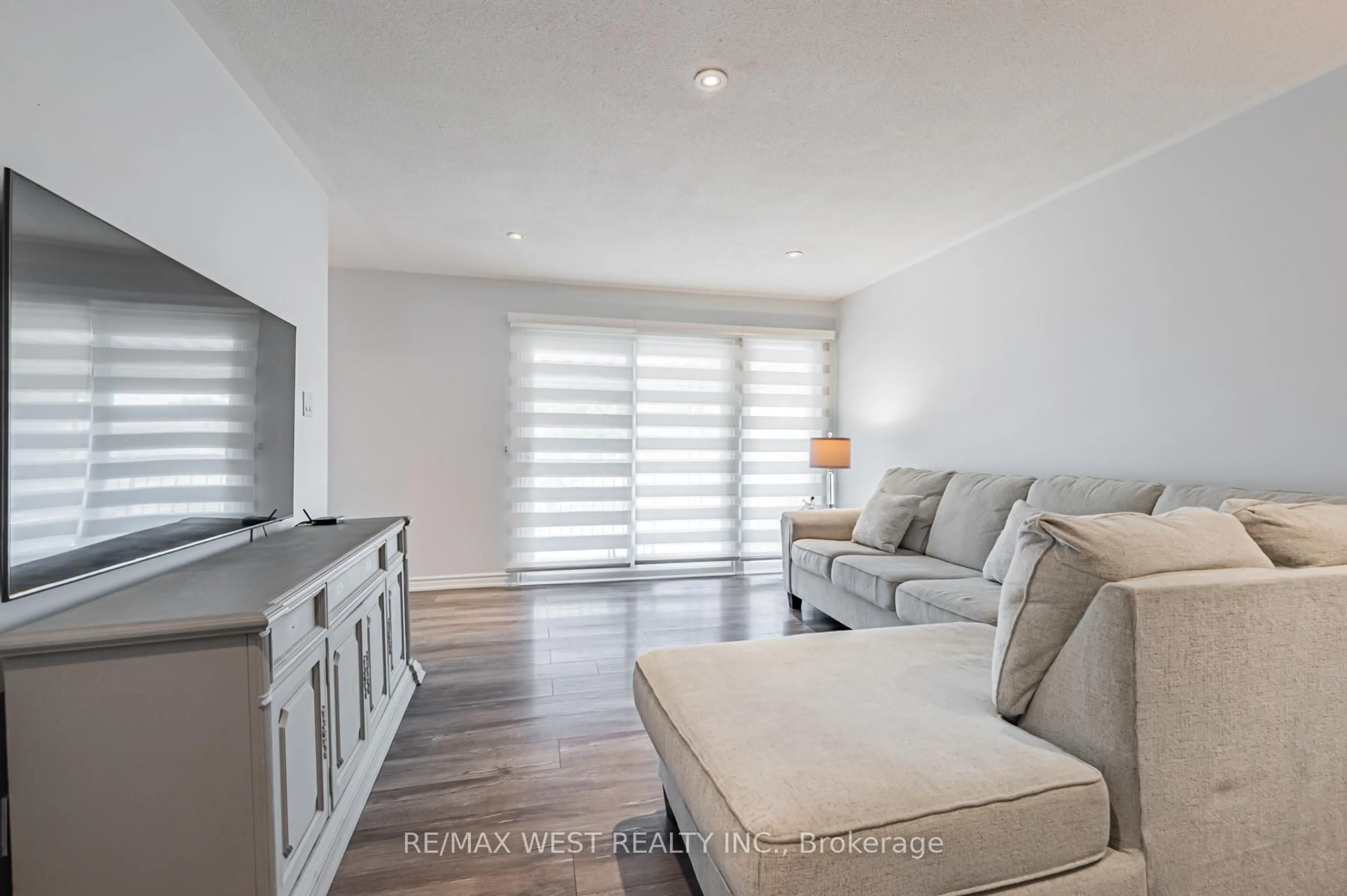 Living room with furniture, wood/laminate floor for 61 Husband Dr, Toronto Ontario M9L 1J8