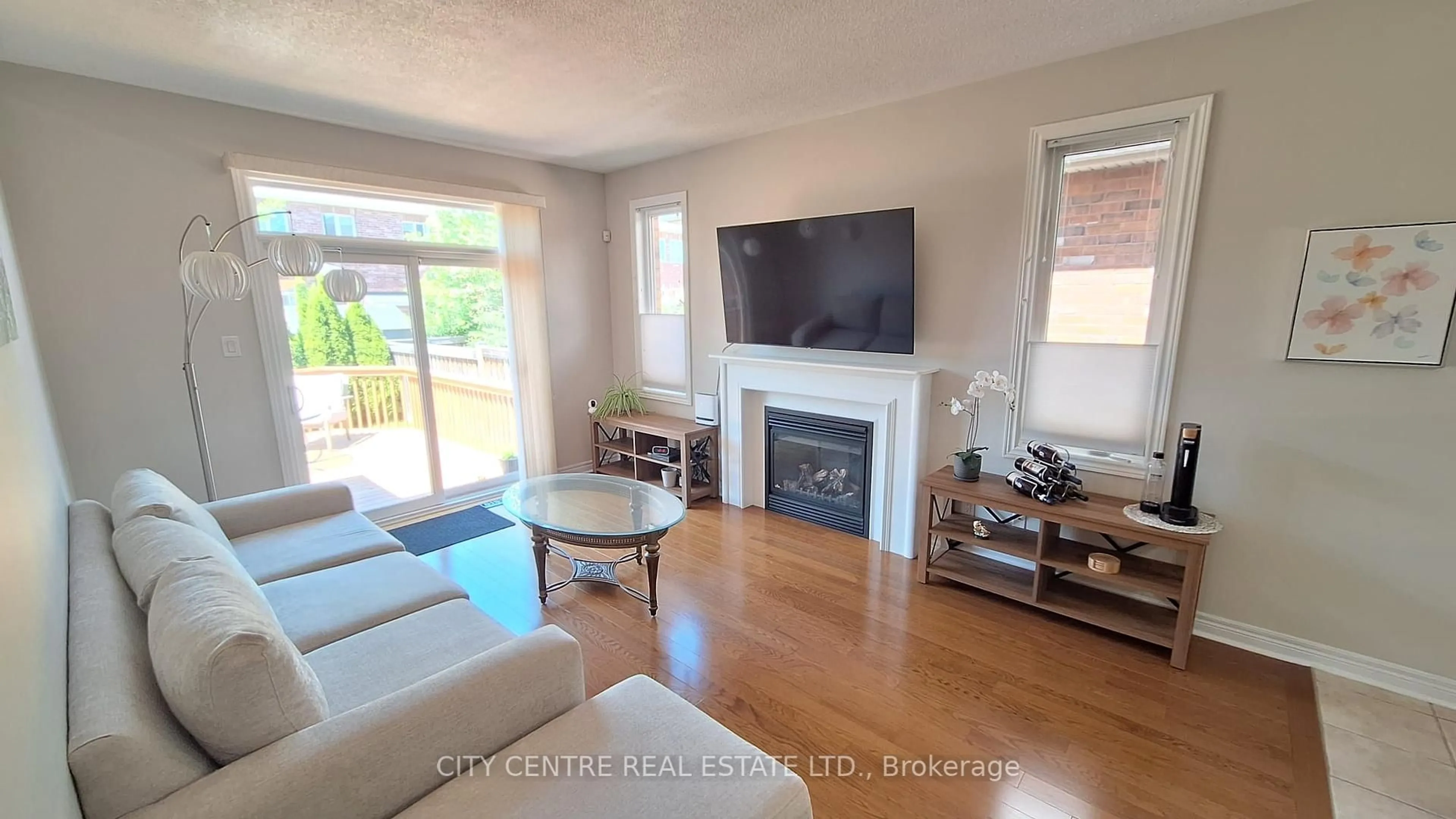 Living room with furniture, wood/laminate floor for 52 Atchison Dr, Caledon Ontario L7C 3R5