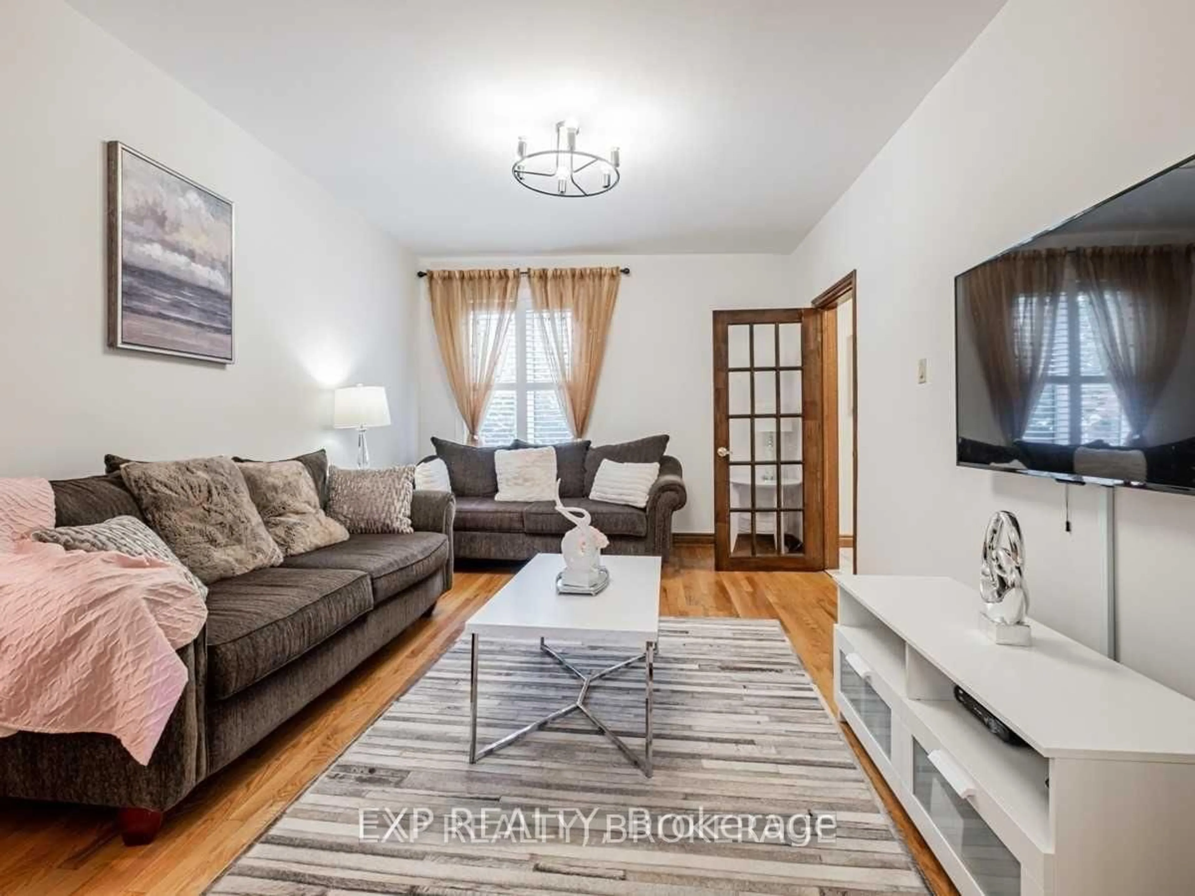 Living room with furniture, wood/laminate floor for 62 Aziel St, Toronto Ontario M6P 2N9