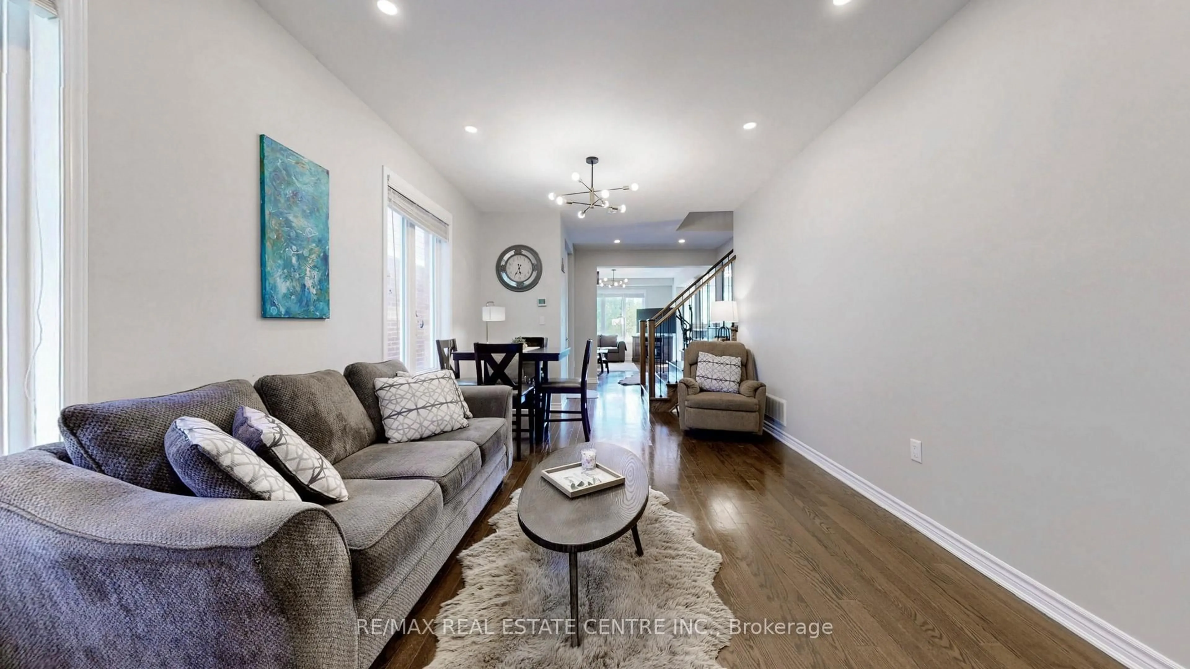 Living room with furniture, wood/laminate floor for 1538 Clitherow St. St, Milton Ontario L9E 0B1