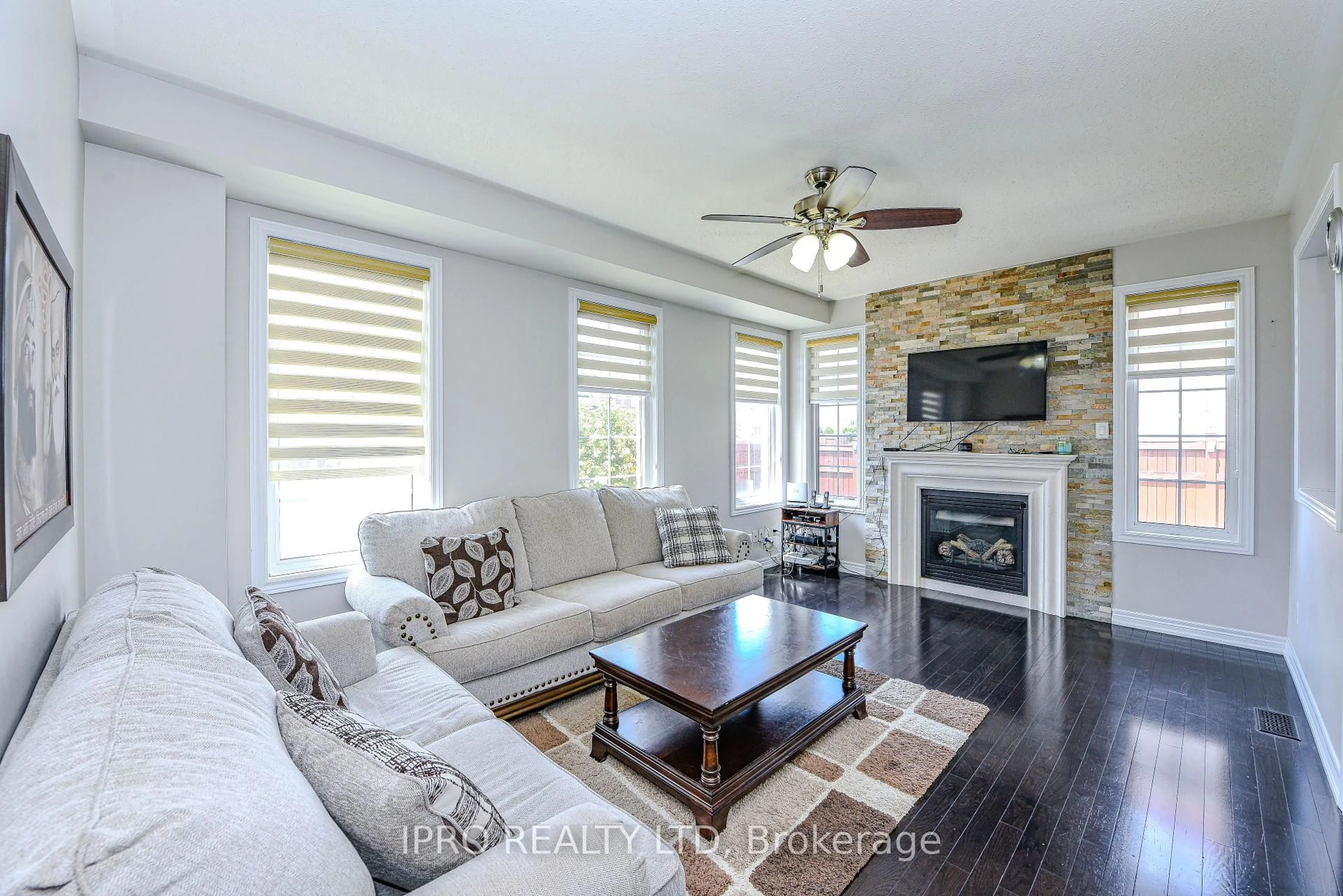 Living room with furniture, wood/laminate floor for 44 Templehill Rd, Brampton Ontario L6R 0Z8