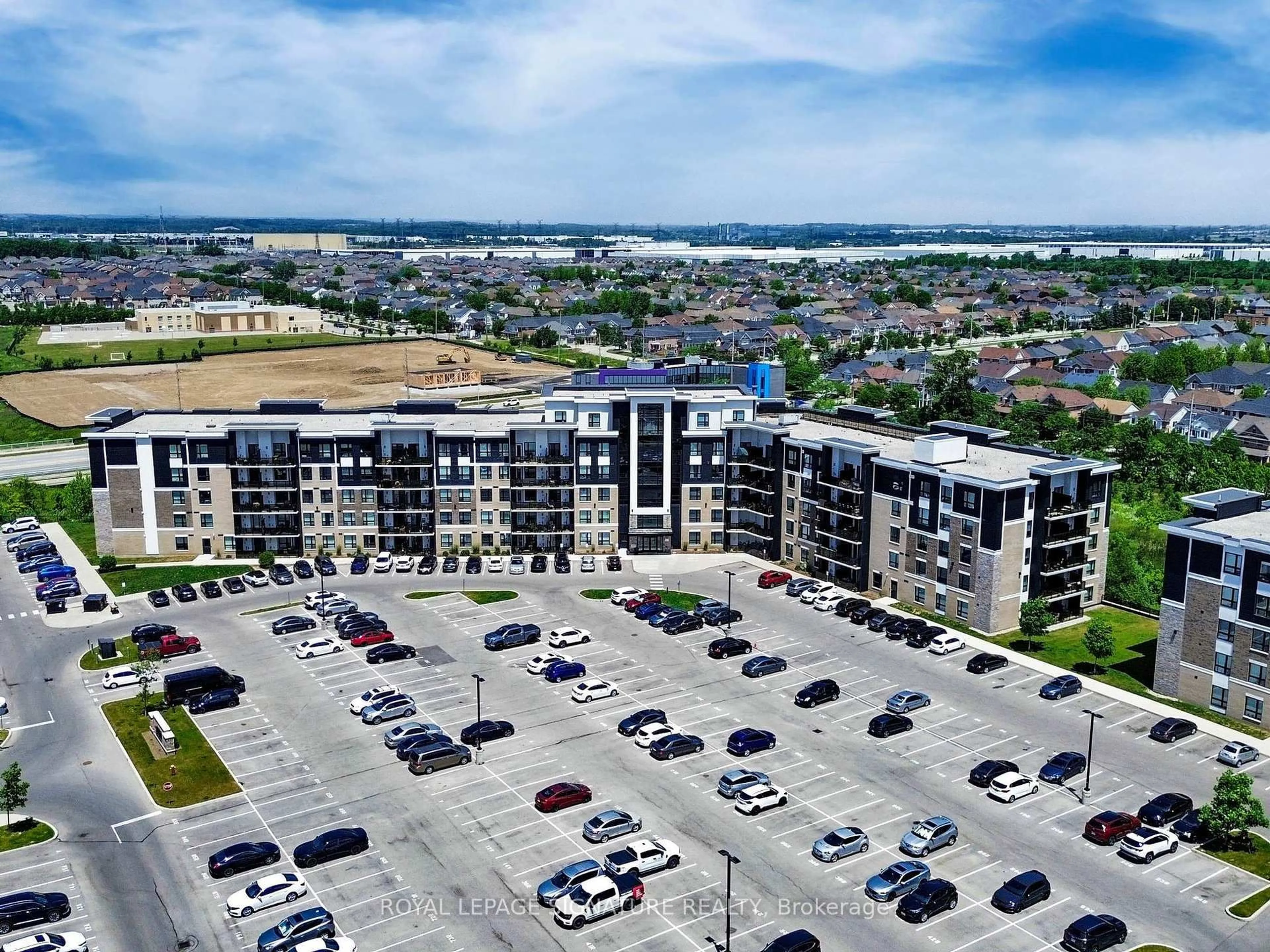 A pic from outside/outdoor area/front of a property/back of a property/a pic from drone, unknown for 630 Sauve St #215, Milton Ontario L9T 9A6