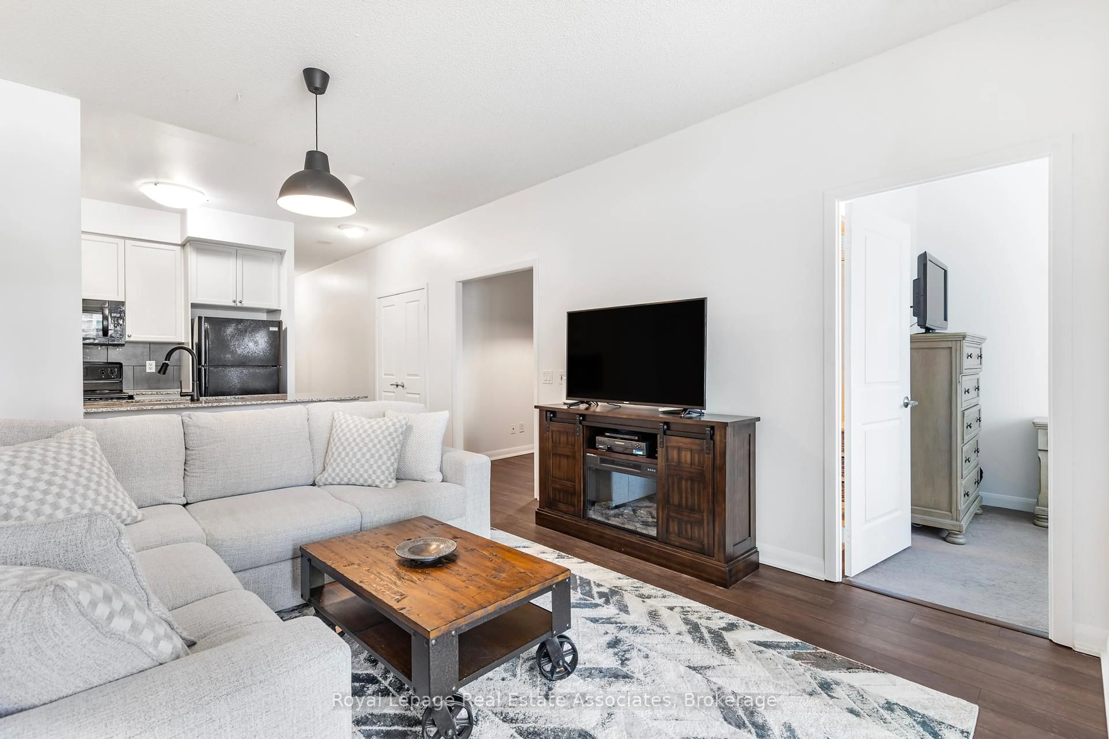 Living room with furniture, wood/laminate floor for 235 Sherway Gardens Rd #103, Toronto Ontario M9C 0A2