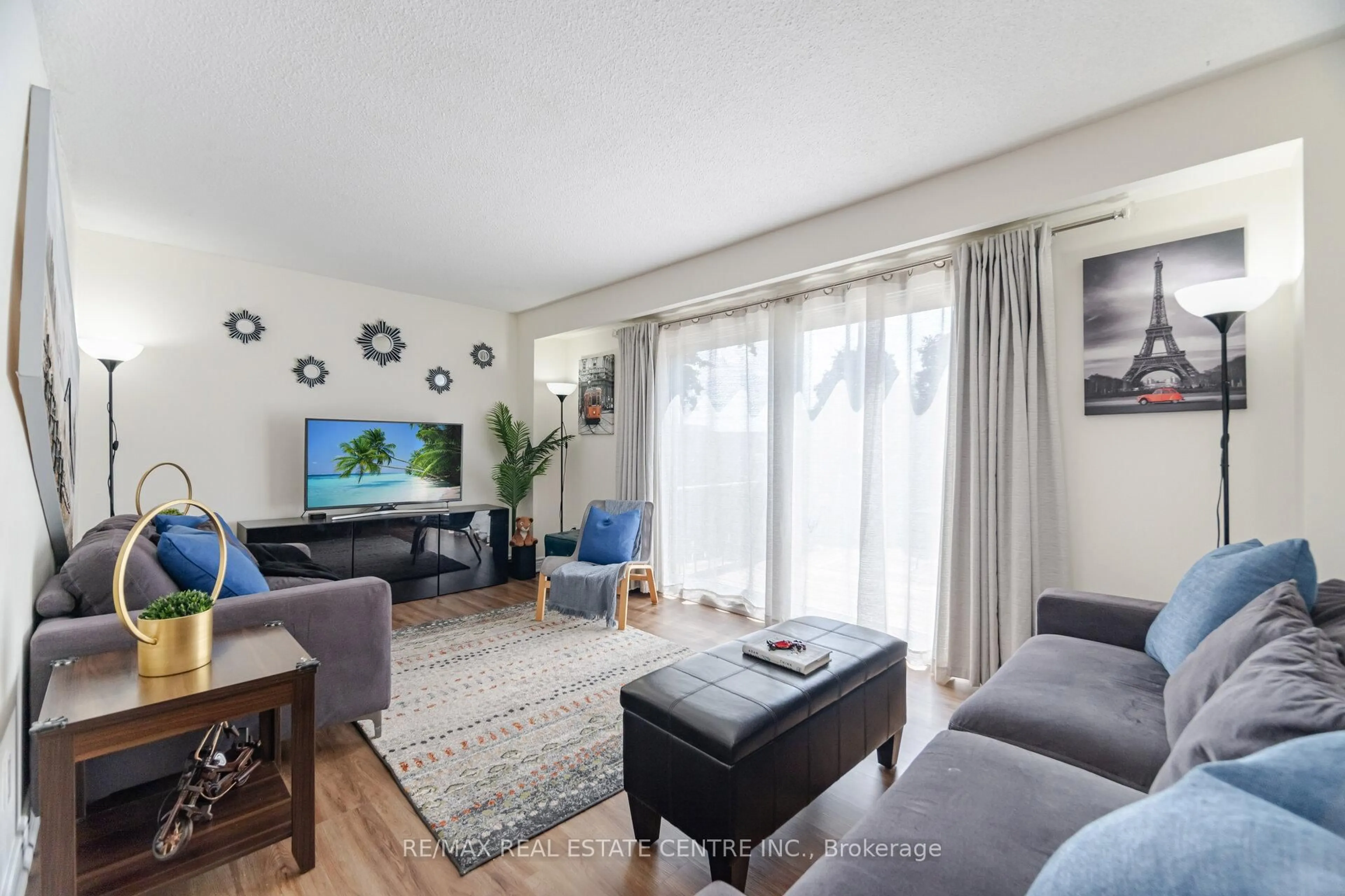Living room with furniture, wood/laminate floor for 30 Heslop Rd #34, Milton Ontario L9T 1B3