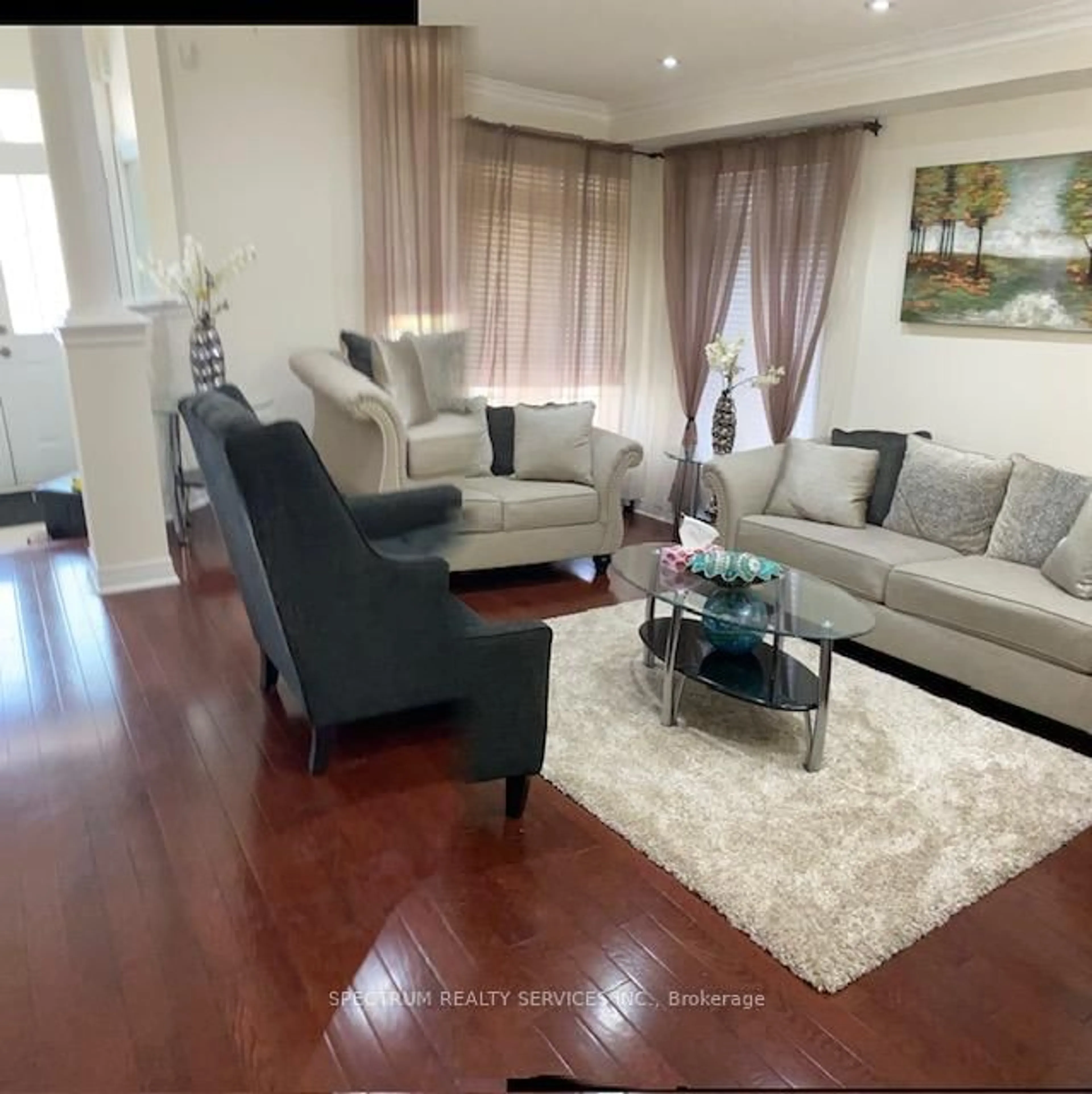 Living room with furniture, wood/laminate floor for 22 Ungava Bay Rd, Brampton Ontario L6R 3M5