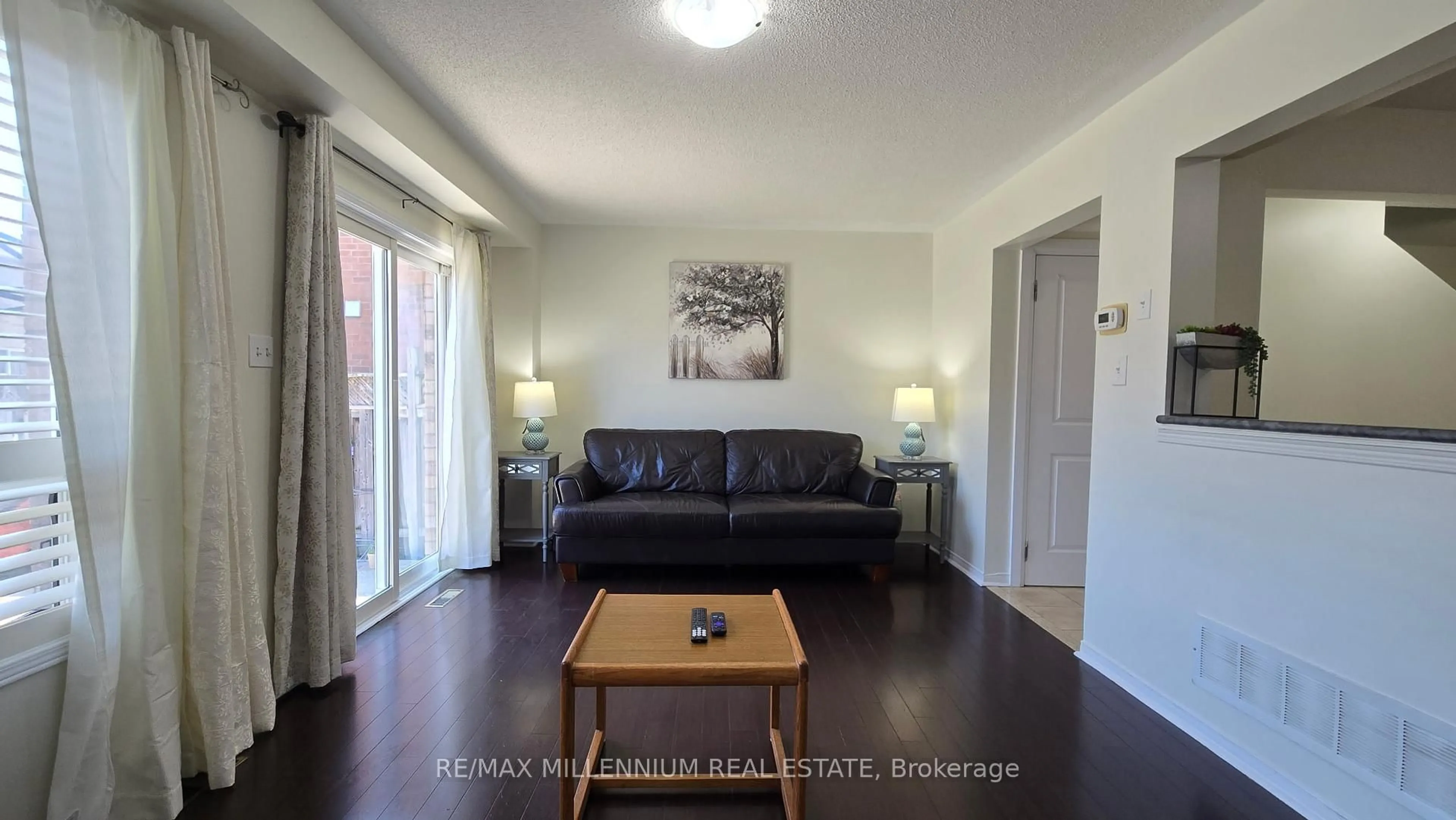 Living room with furniture, wood/laminate floor for 63 Roadmaster Lane, Brampton Ontario L7A 3A7