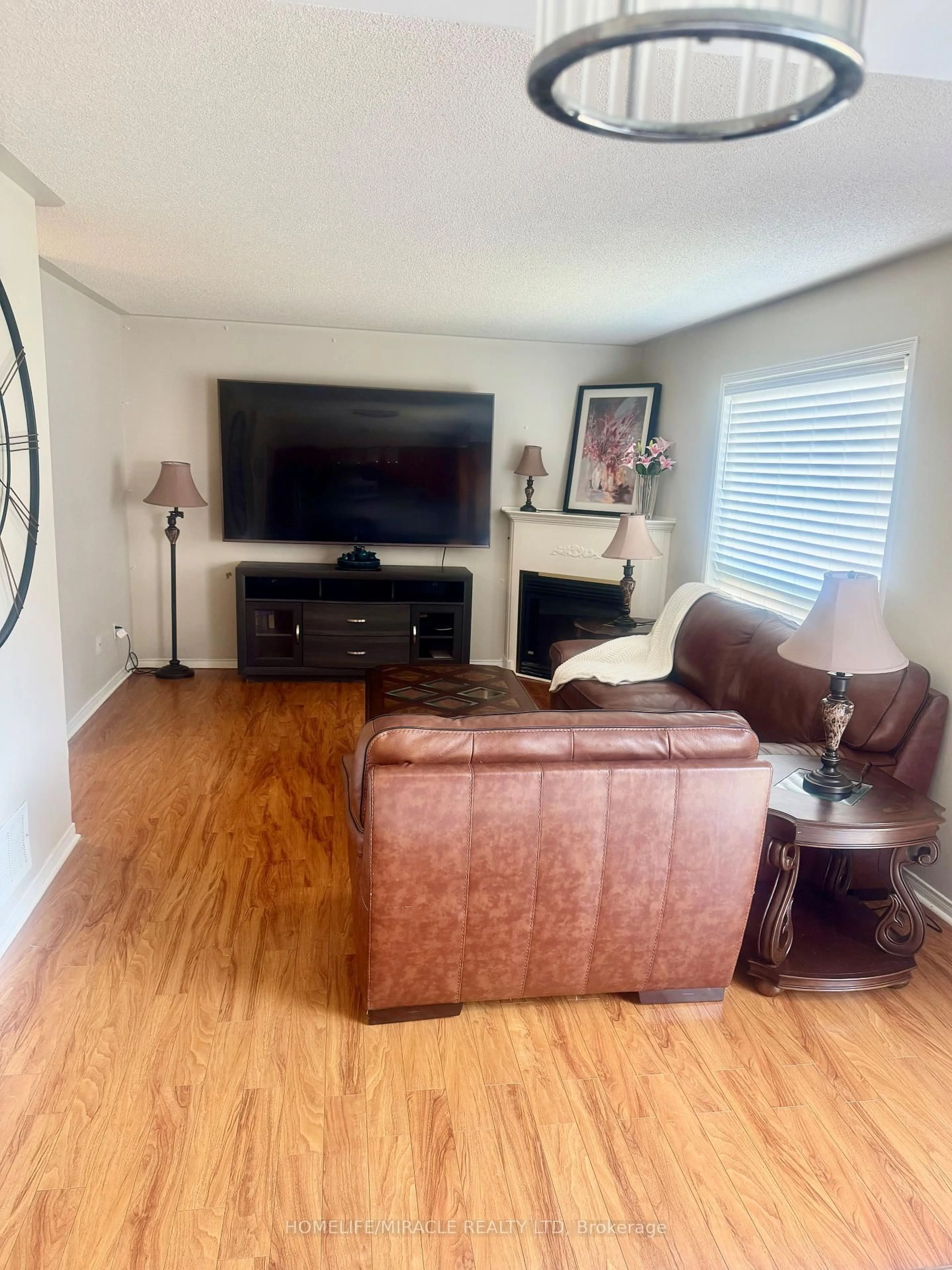 Living room with furniture, wood/laminate floor for 65 Fairhill Ave, Brampton Ontario L7A 2E8