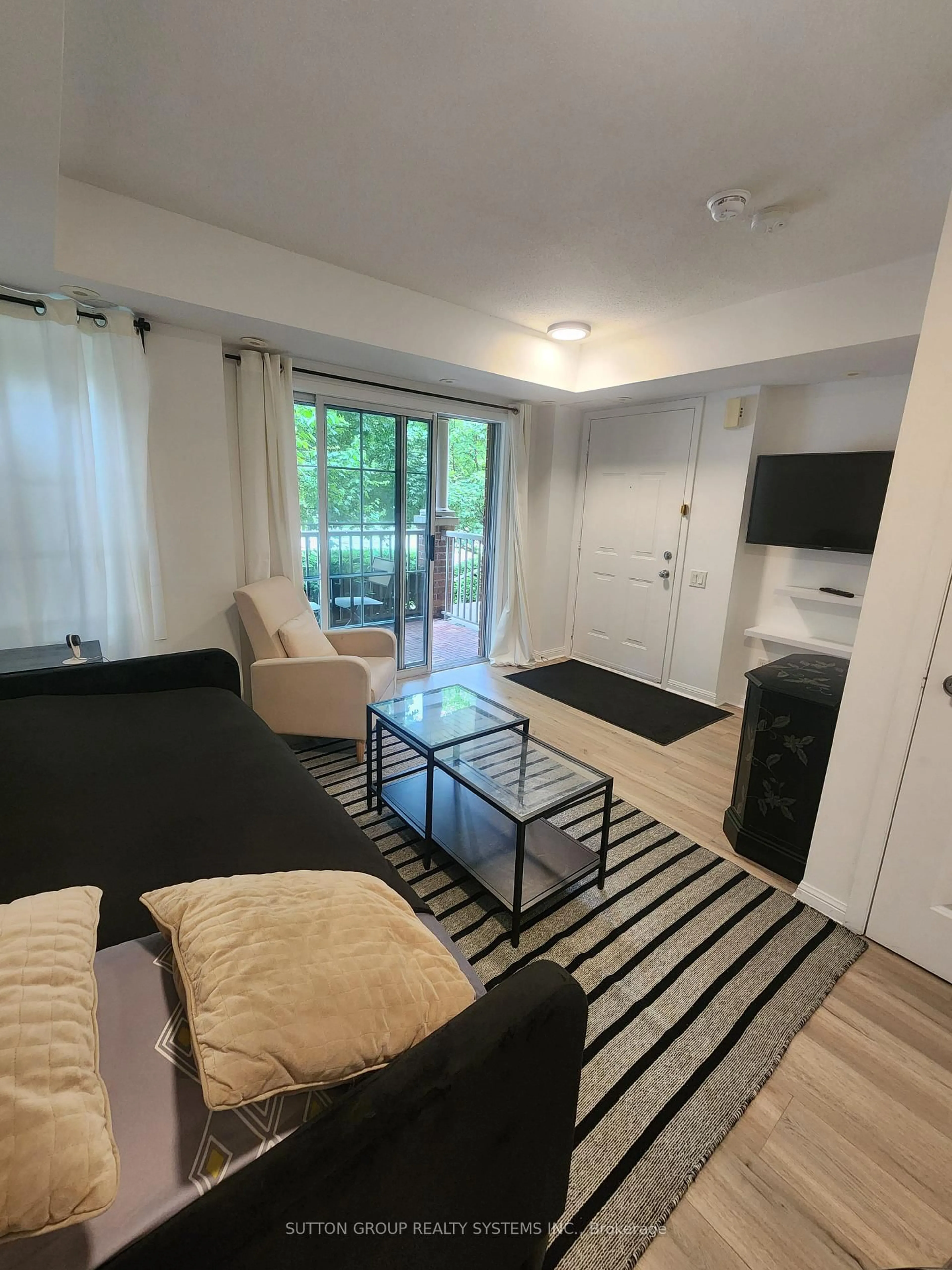 Living room with furniture, wood/laminate floor for 93 The Queensway #TH20, Toronto Ontario M6S 5A7