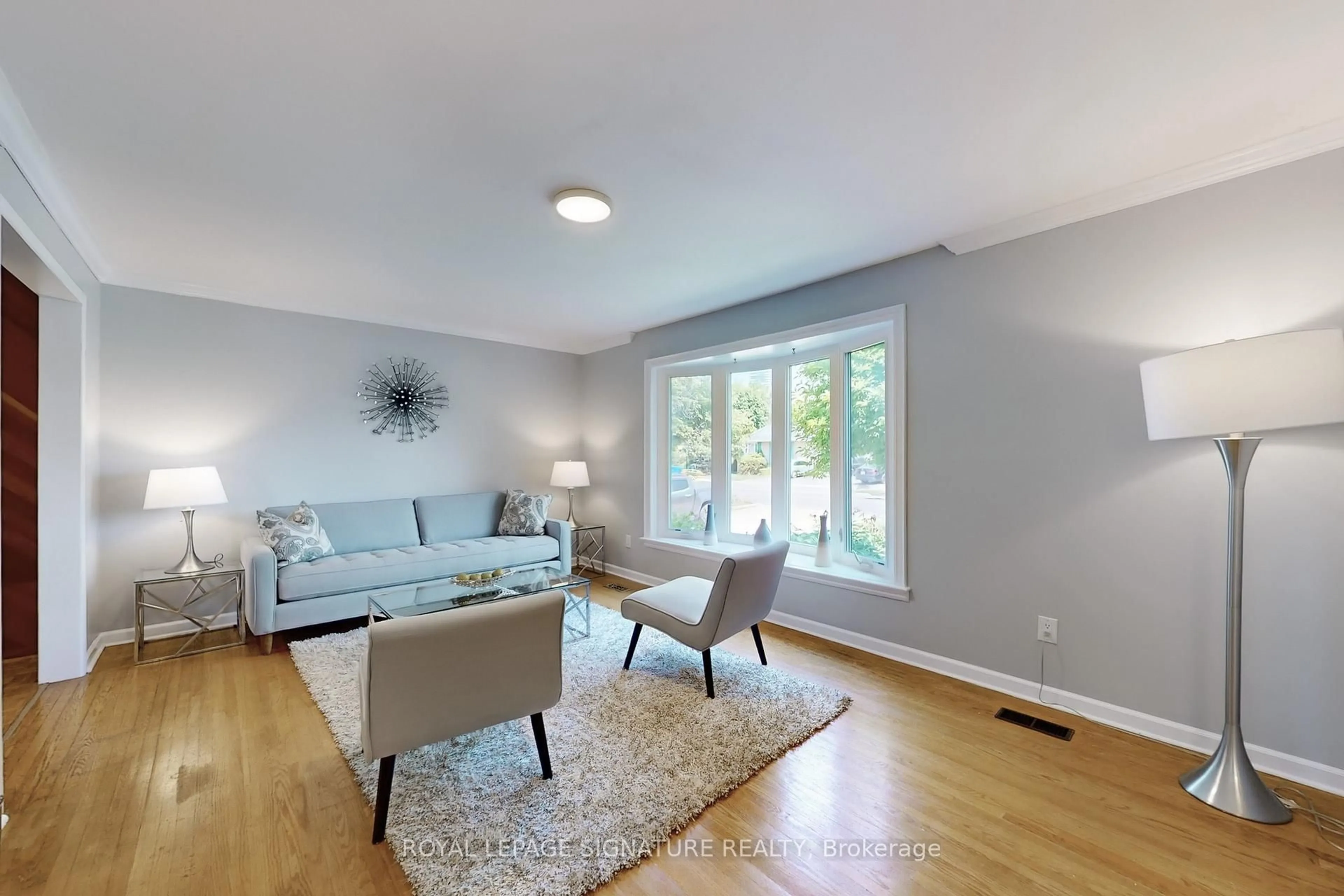 Living room with furniture, wood/laminate floor for 61 Centre St, Brampton Ontario L6W 2X7