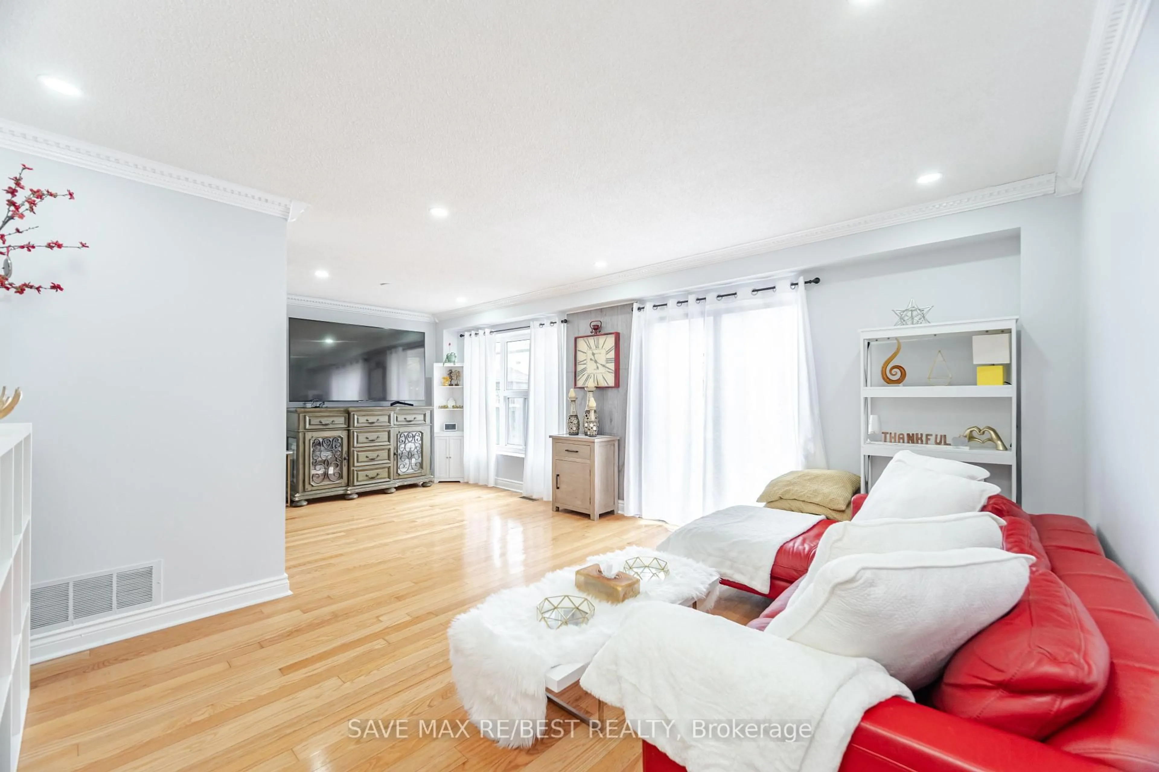 Living room with furniture, wood/laminate floor for 14 Rustywood Dr, Brampton Ontario L6Y 2W2