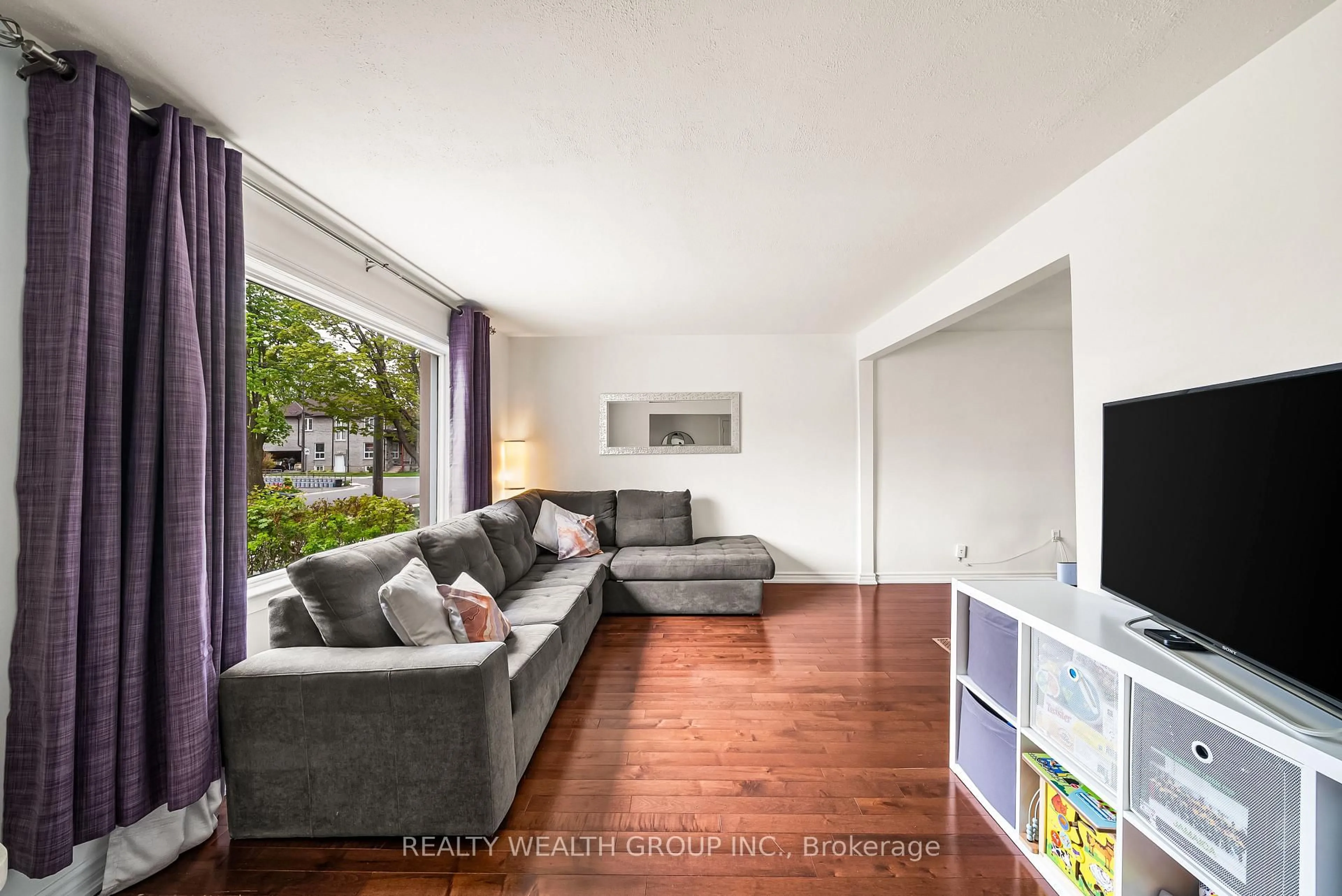 Living room with furniture, wood/laminate floor for 17 Haymarket Rd, Toronto Ontario M3L 1H3