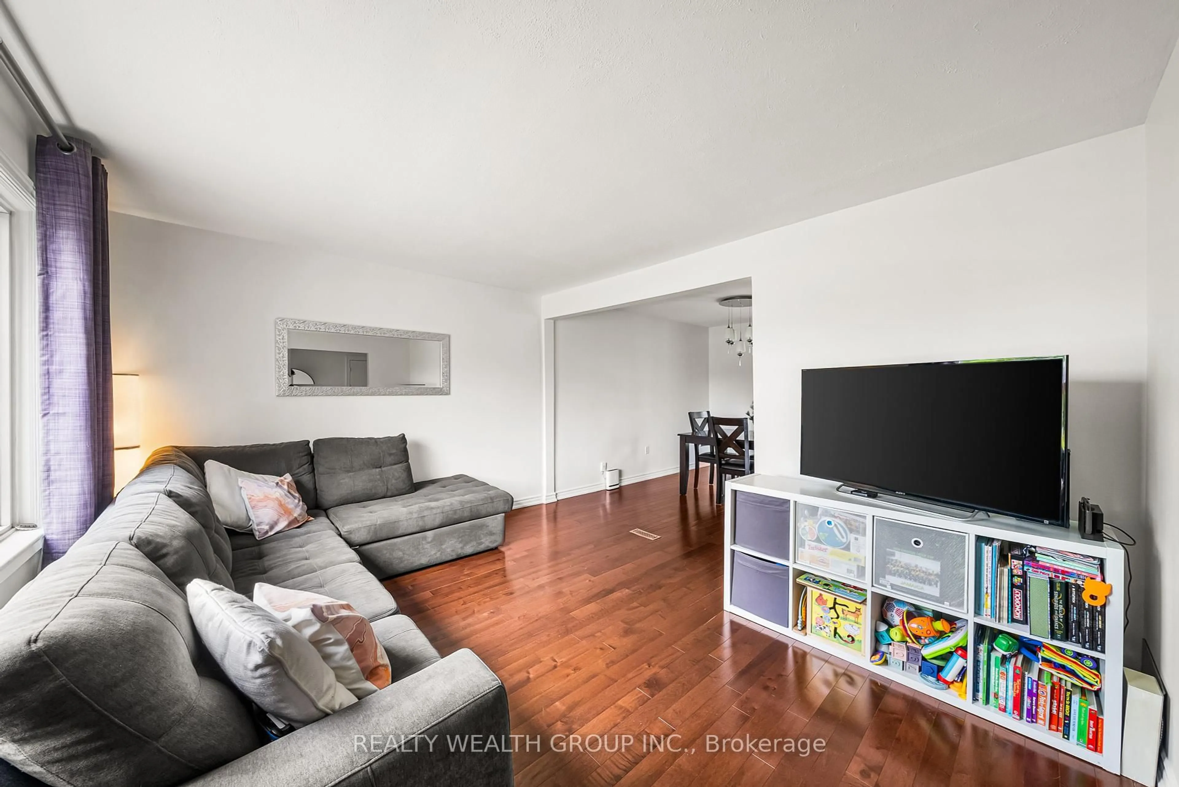 Living room with furniture, wood/laminate floor for 17 Haymarket Rd, Toronto Ontario M3L 1H3