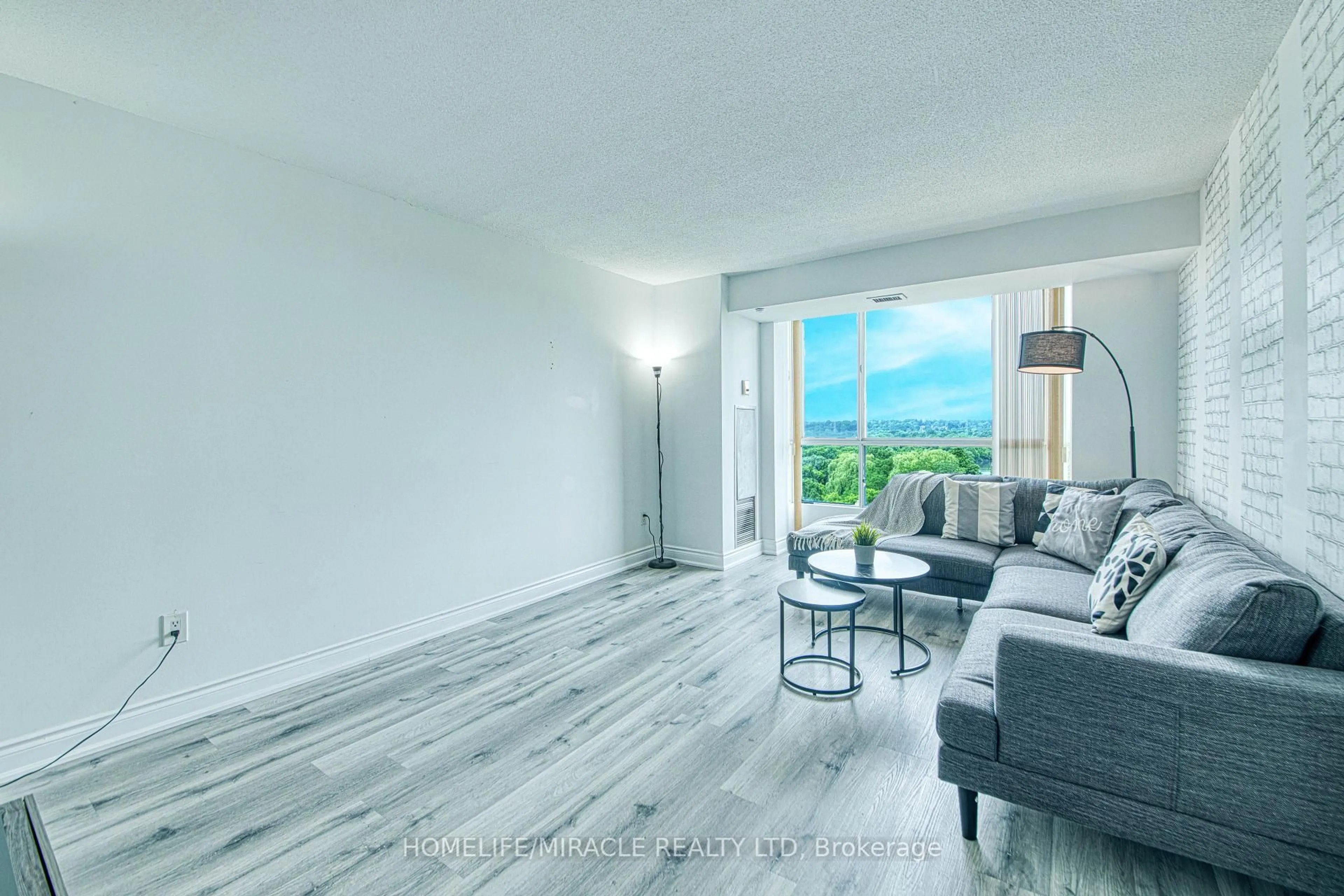 Living room with furniture, wood/laminate floor for 3077 Weston Rd #1004, Toronto Ontario M9M 3A1