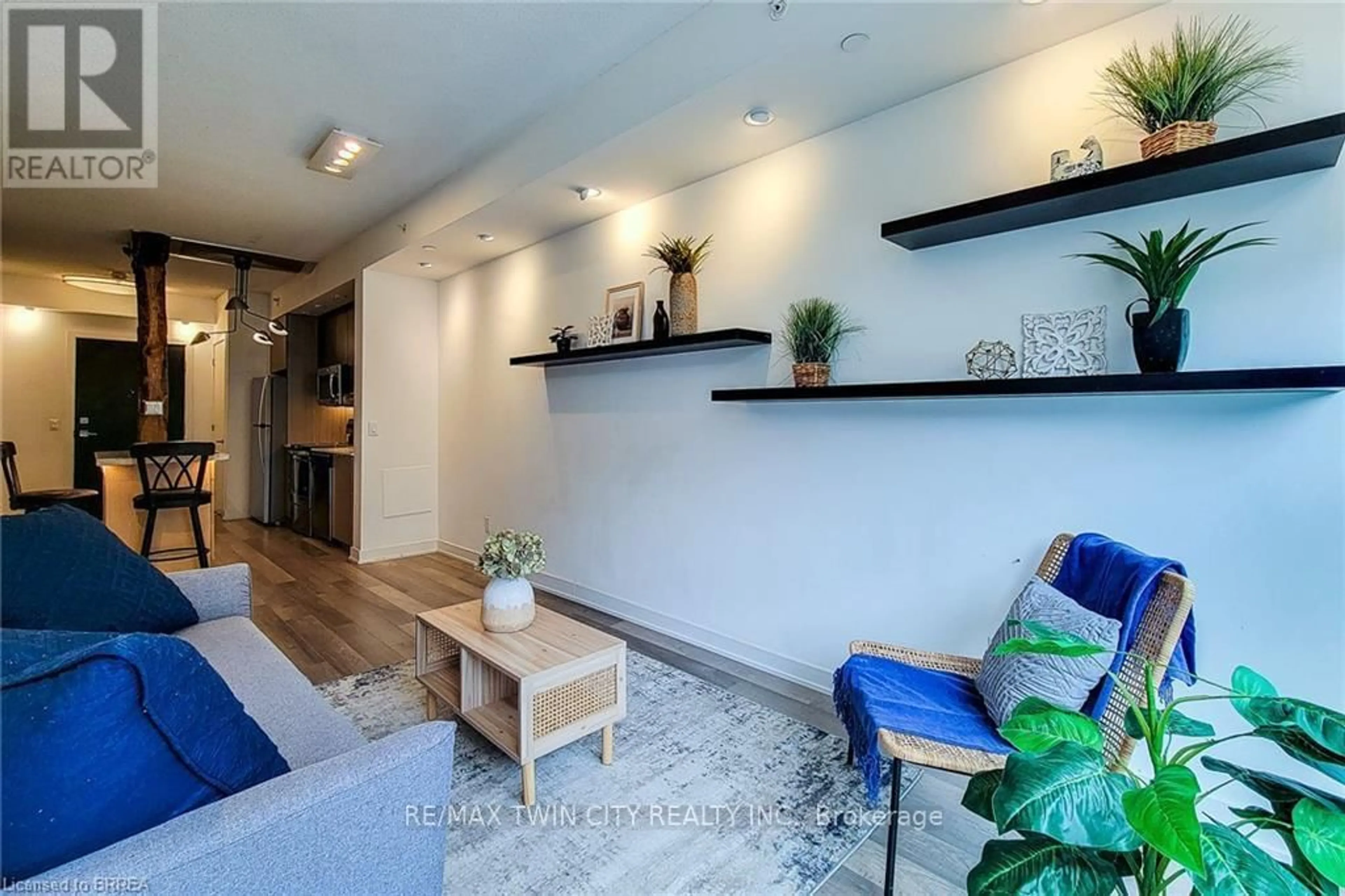 Living room with furniture, wood/laminate floor for 5240 Dundas St #215, Burlington Ontario L7L 0J6