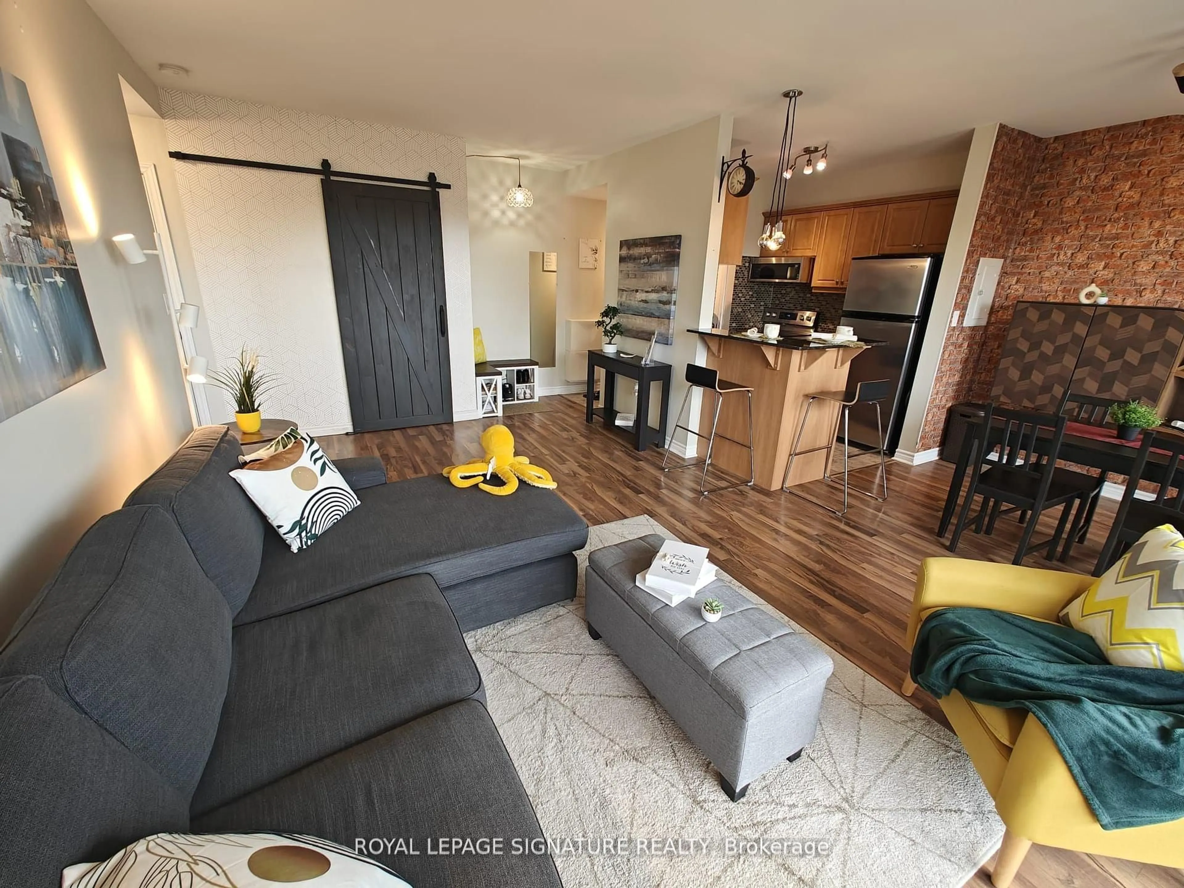 Living room with furniture, wood/laminate floor for 60 Gulliver Rd #404, Toronto Ontario M6M 2A6