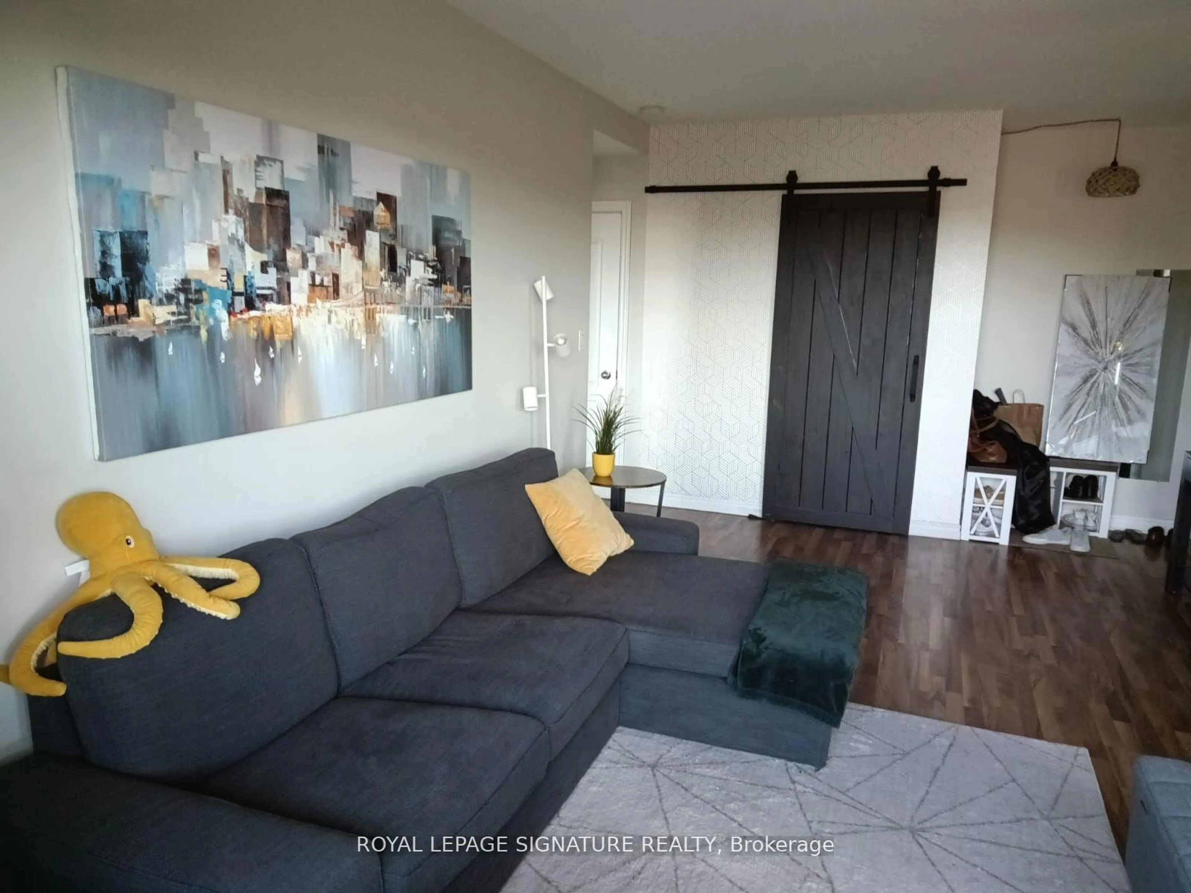 Living room with furniture, wood/laminate floor for 60 Gulliver Rd #404, Toronto Ontario M6M 2A6