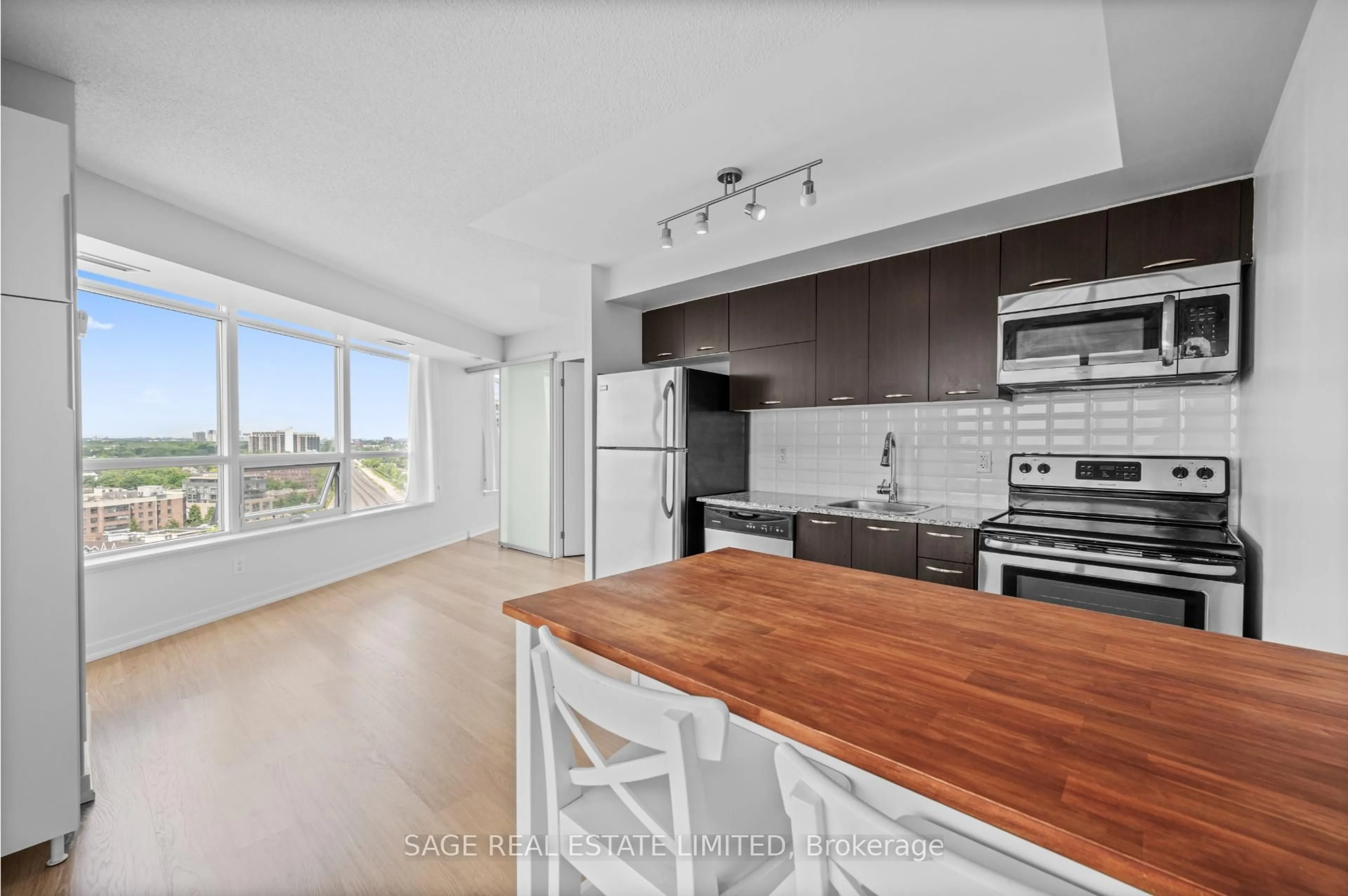 Open concept kitchen, wood/laminate floor for 38 Joe Shuster Way #1518, Toronto Ontario M6K 0A5