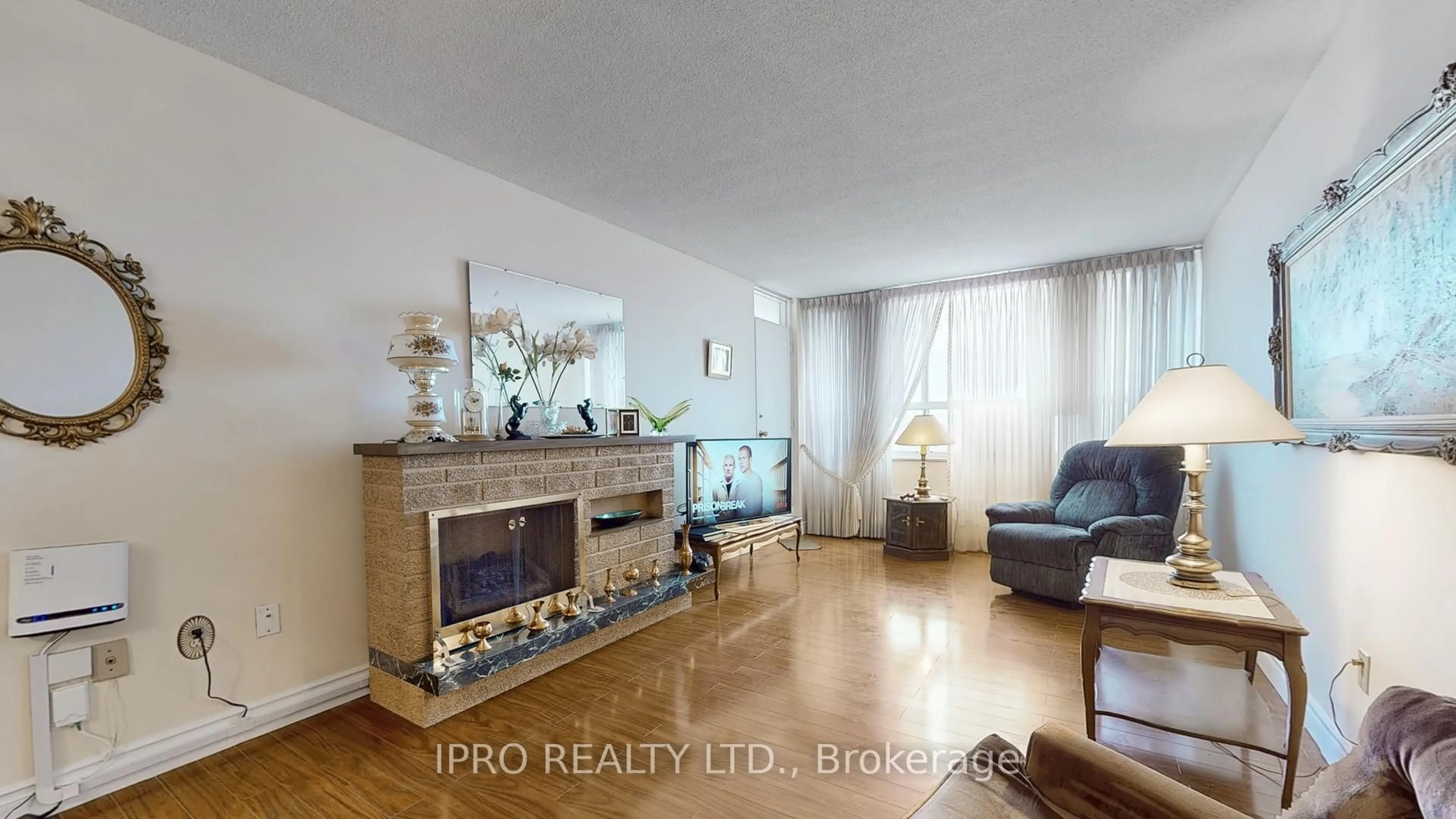 Living room with furniture, wood/laminate floor for 390 Dixon Rd #909, Toronto Ontario M9R 1T4