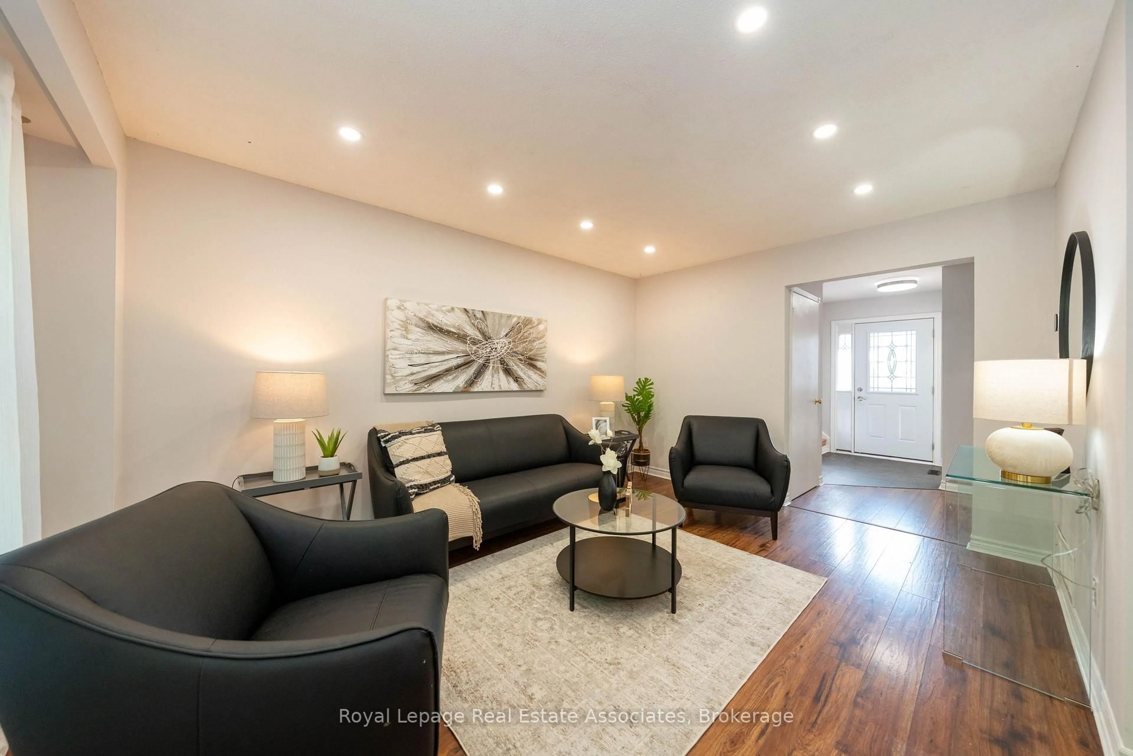Living room with furniture, wood/laminate floor for 19 Burbank Cres, Orangeville Ontario L9W 3E6