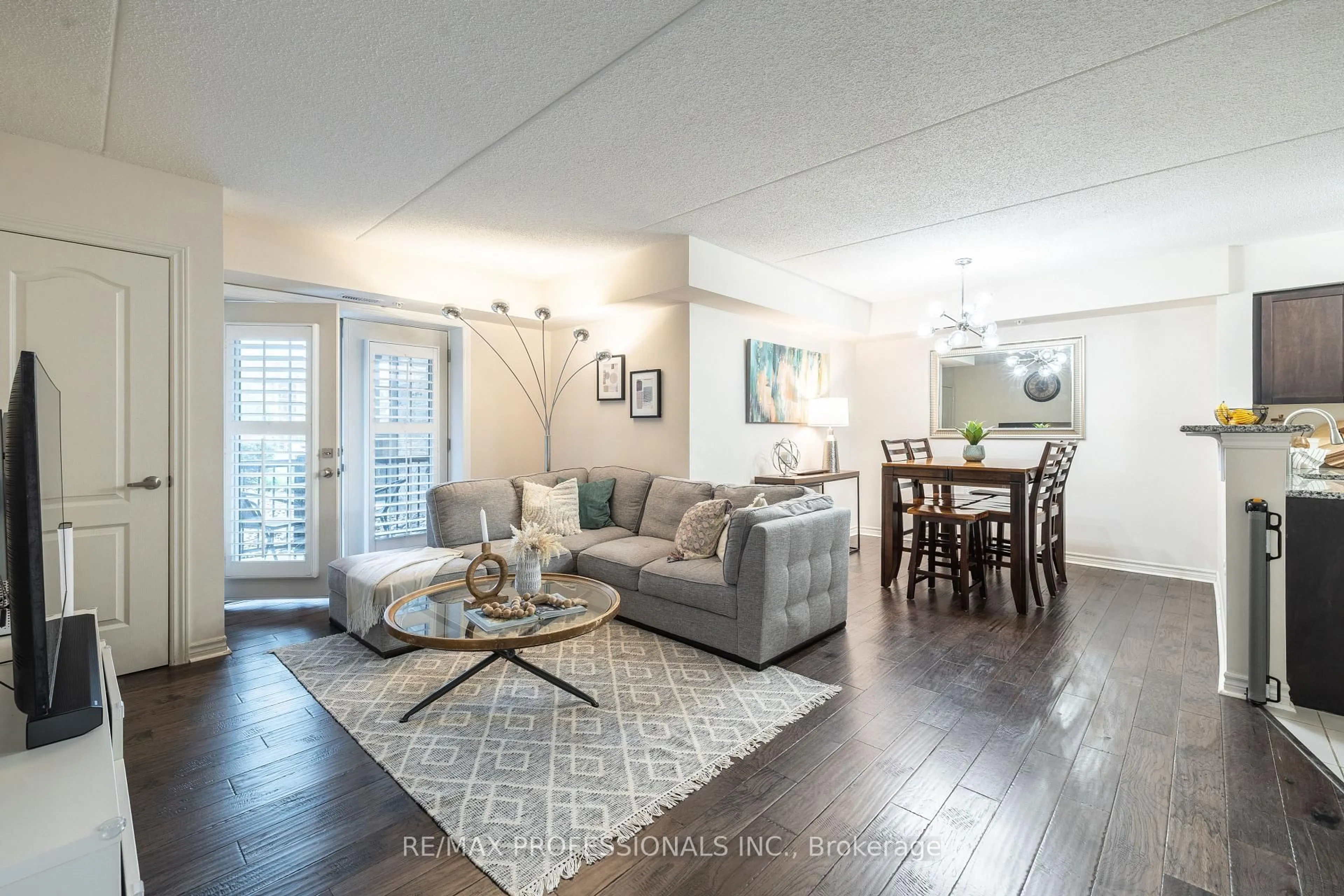 Living room with furniture, wood/laminate floor for 1440 Main St #108, Milton Ontario L9T 8W3