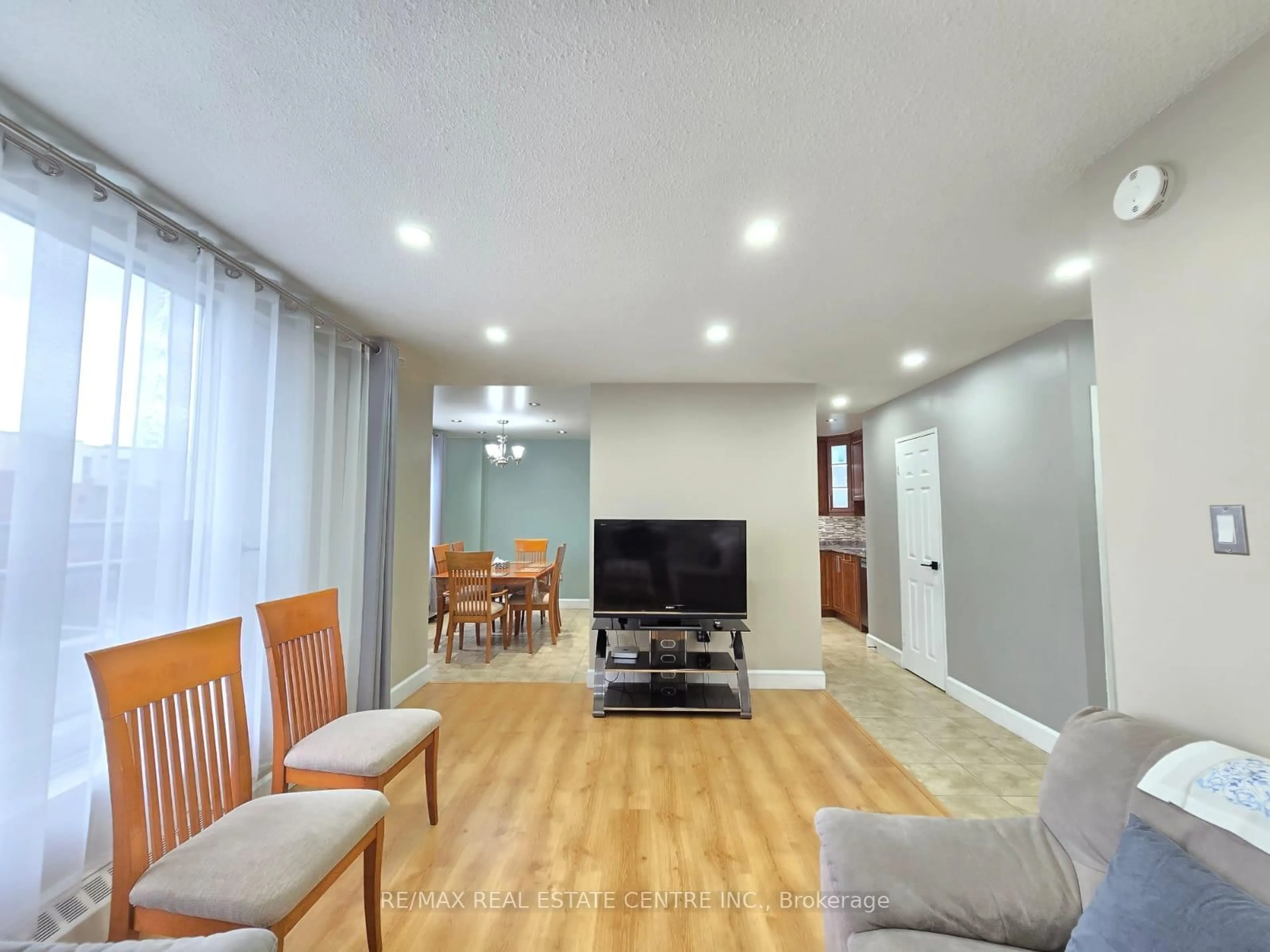 Living room with furniture, wood/laminate floor for 1055 A Forestwood Dr #212, Mississauga Ontario L5C 2T8