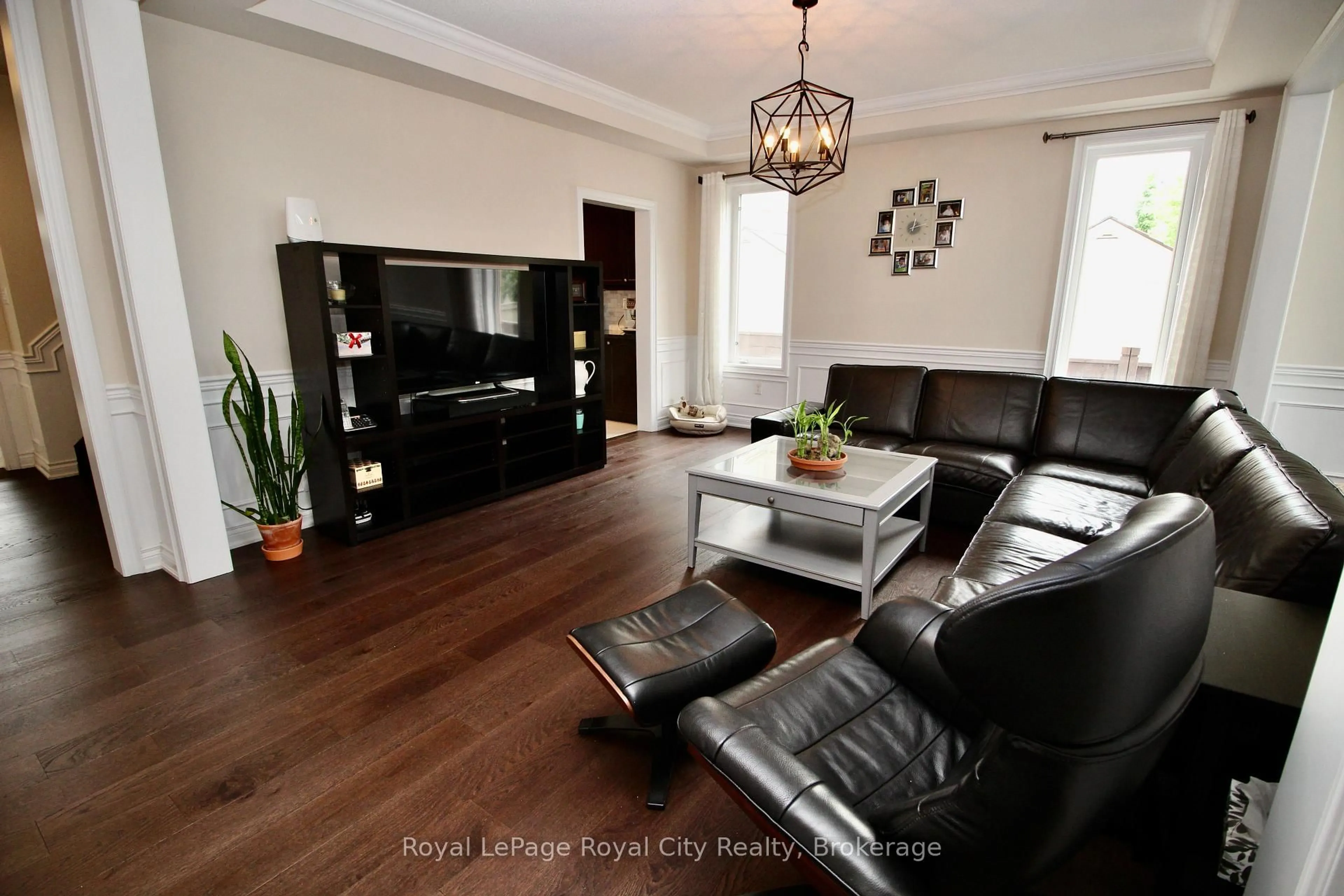 Living room with furniture, wood/laminate floor for 39 Dalmeny Dr, Brampton Ontario L6X 2Y4