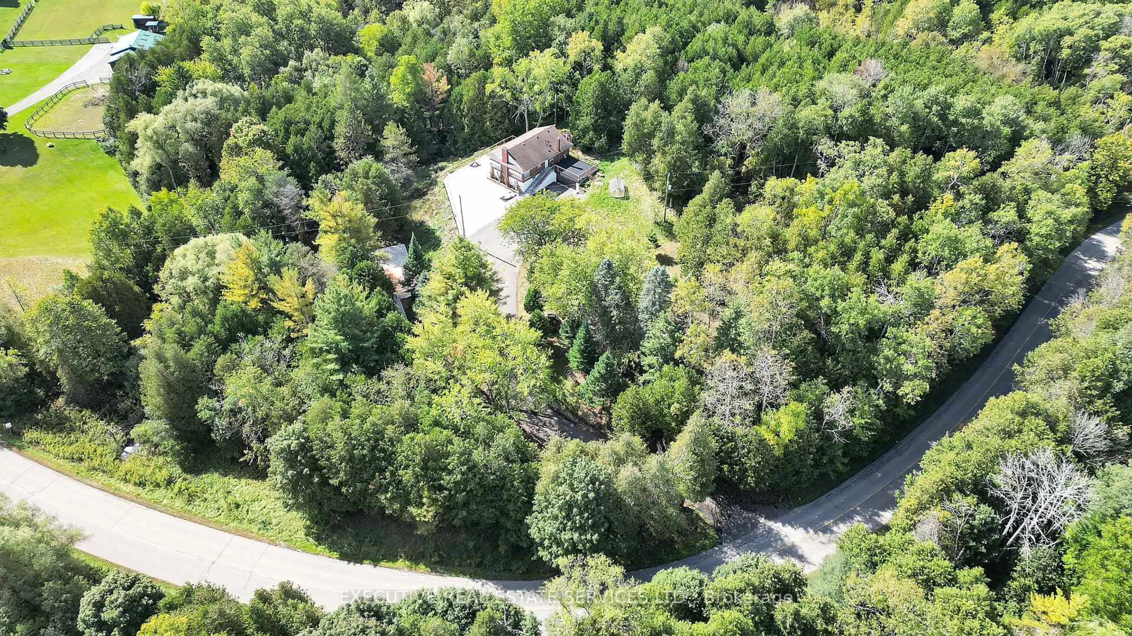 A pic from outside/outdoor area/front of a property/back of a property/a pic from drone, forest/trees view for 16198 Centreville Creek Rd, Caledon Ontario L7C 3B4