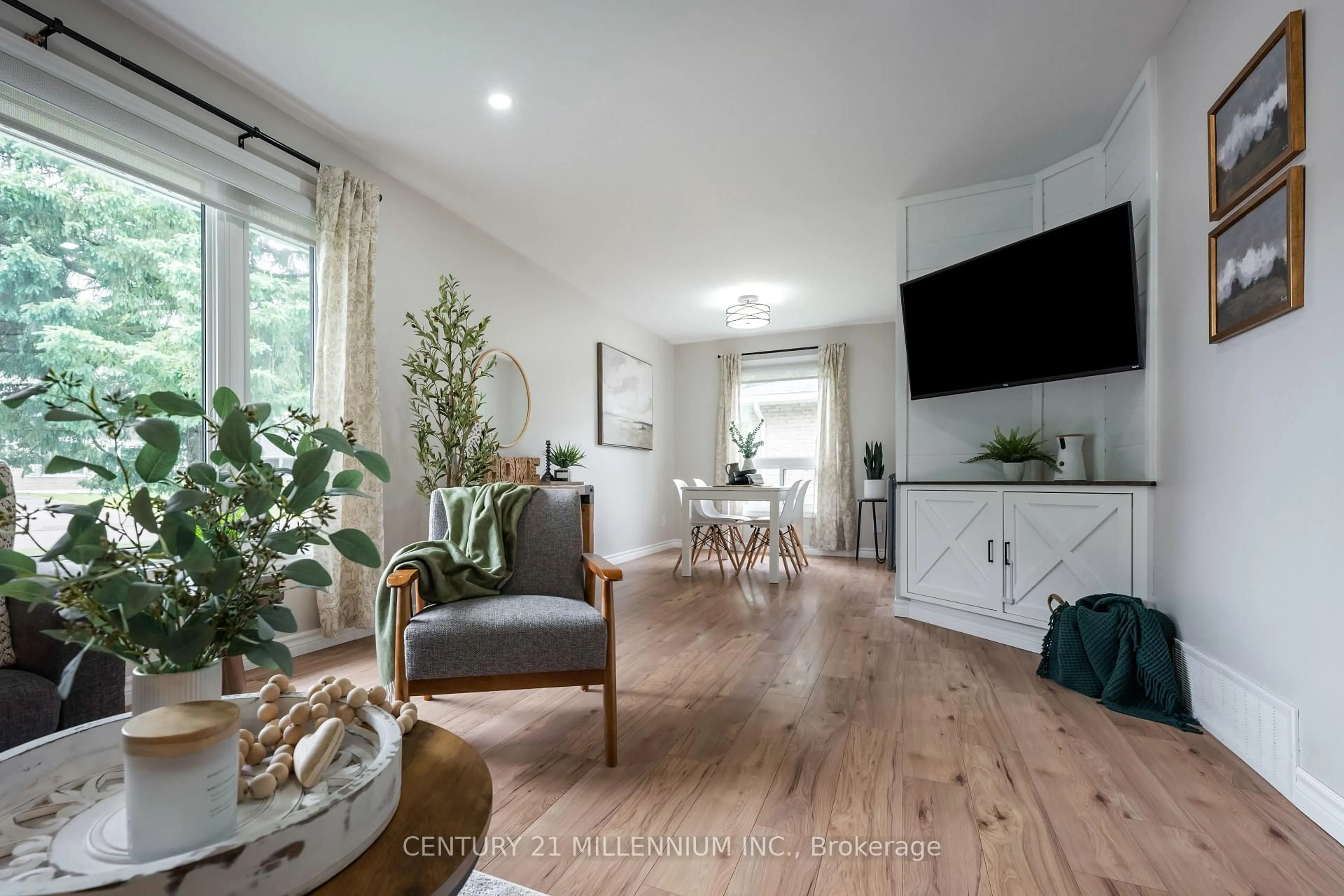 Living room with furniture, wood/laminate floor for 33 Caledonia Rd, Orangeville Ontario L9W 2V2