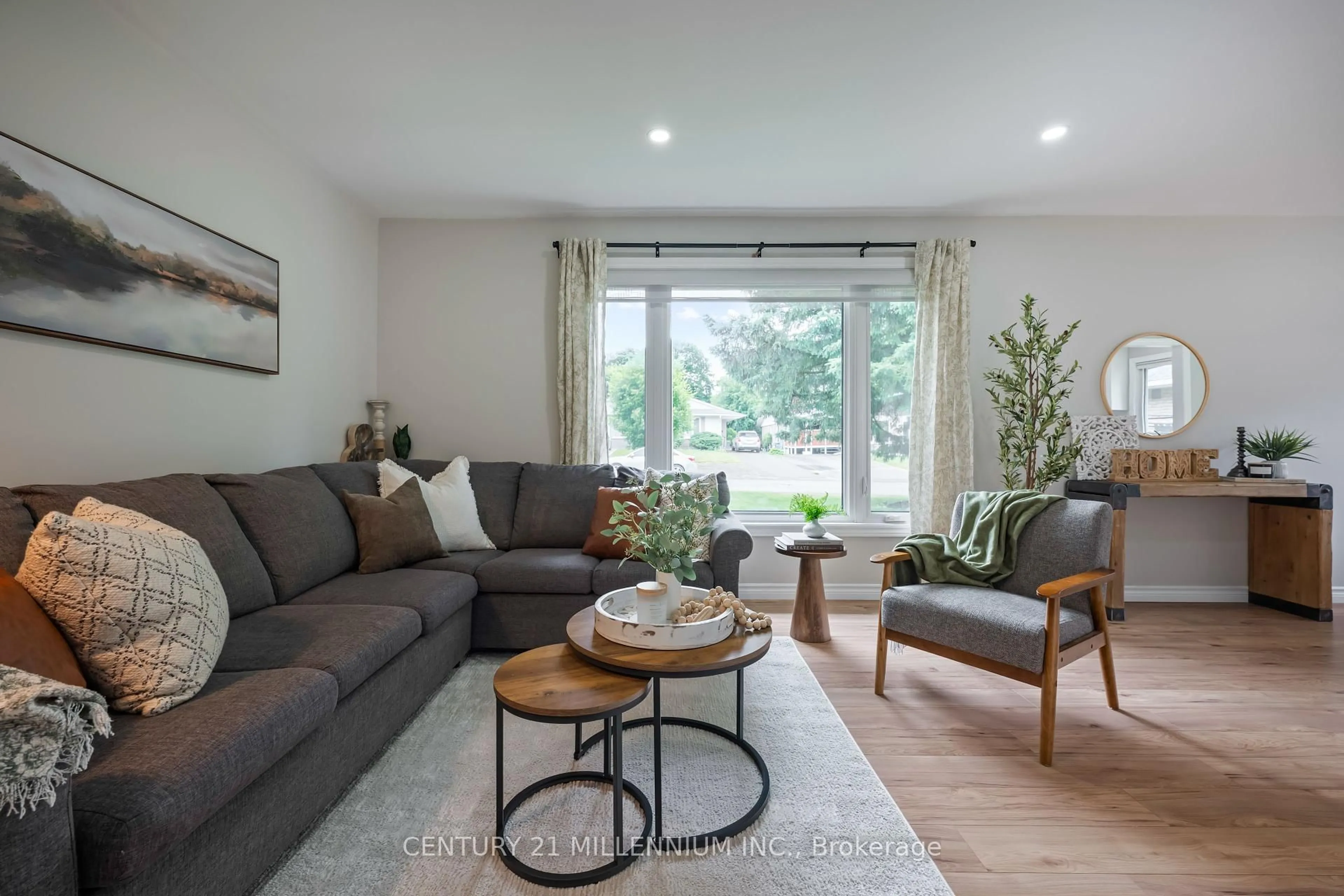 Living room with furniture, wood/laminate floor for 33 Caledonia Rd, Orangeville Ontario L9W 2V2