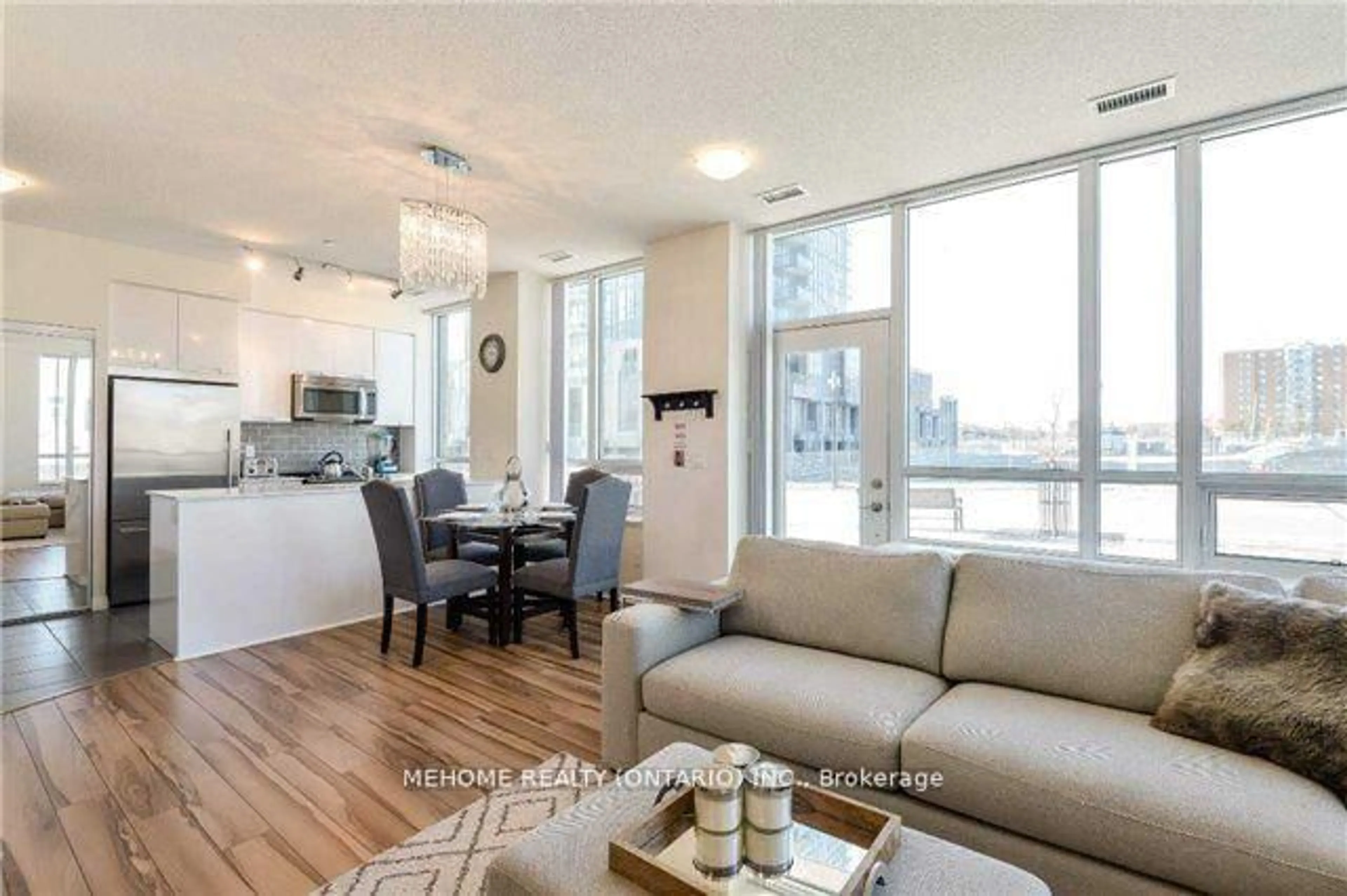 Living room with furniture, wood/laminate floor for 55 Eglinton Ave #103, Mississauga Ontario L5M 8E4