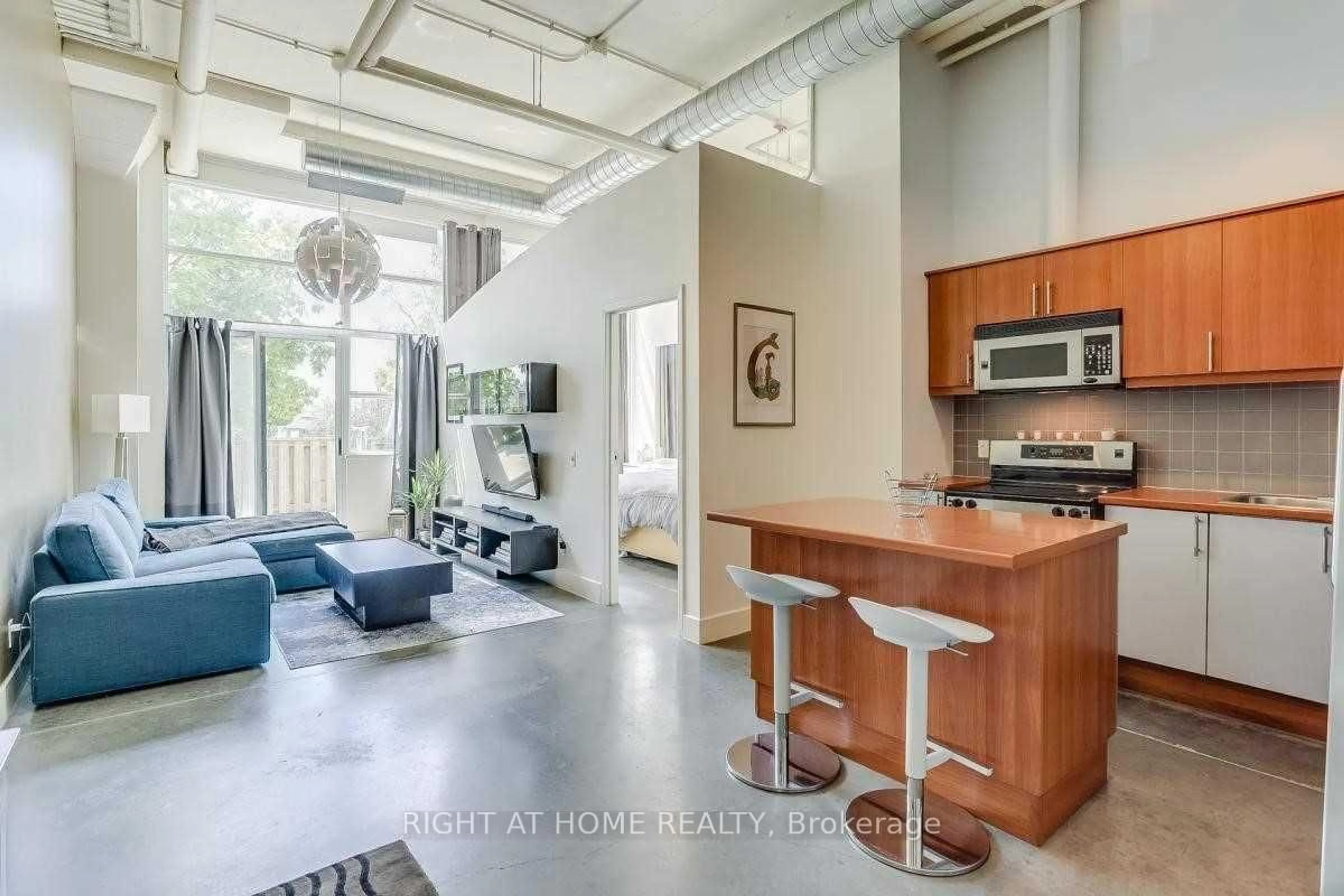 Open concept kitchen, cement floor for 1001 Roselawn Ave #109, Toronto Ontario M6B 4M4