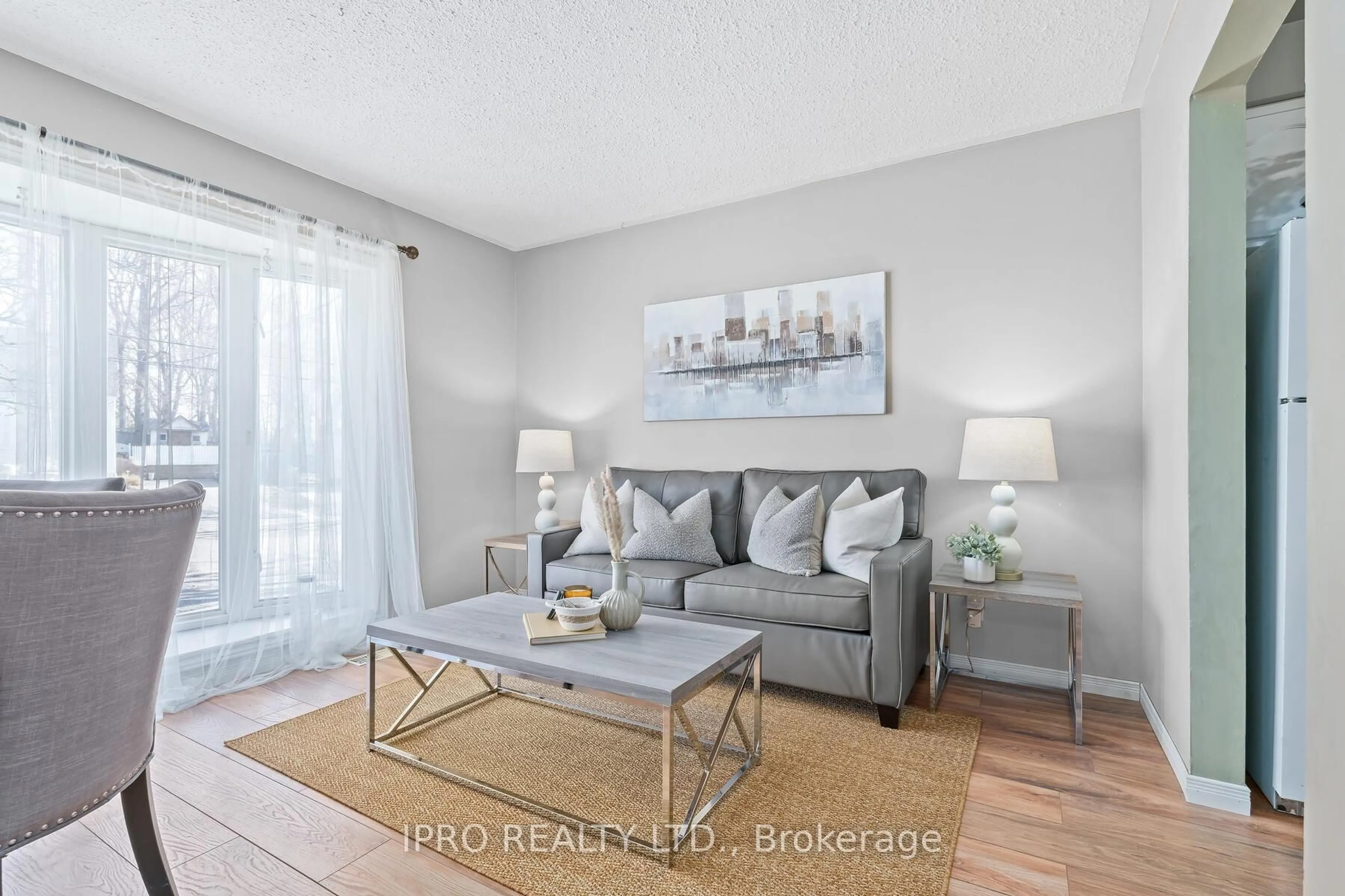 Living room with furniture, wood/laminate floor for 19 Dayfoot Dr, Halton Hills Ontario L7G 2K8