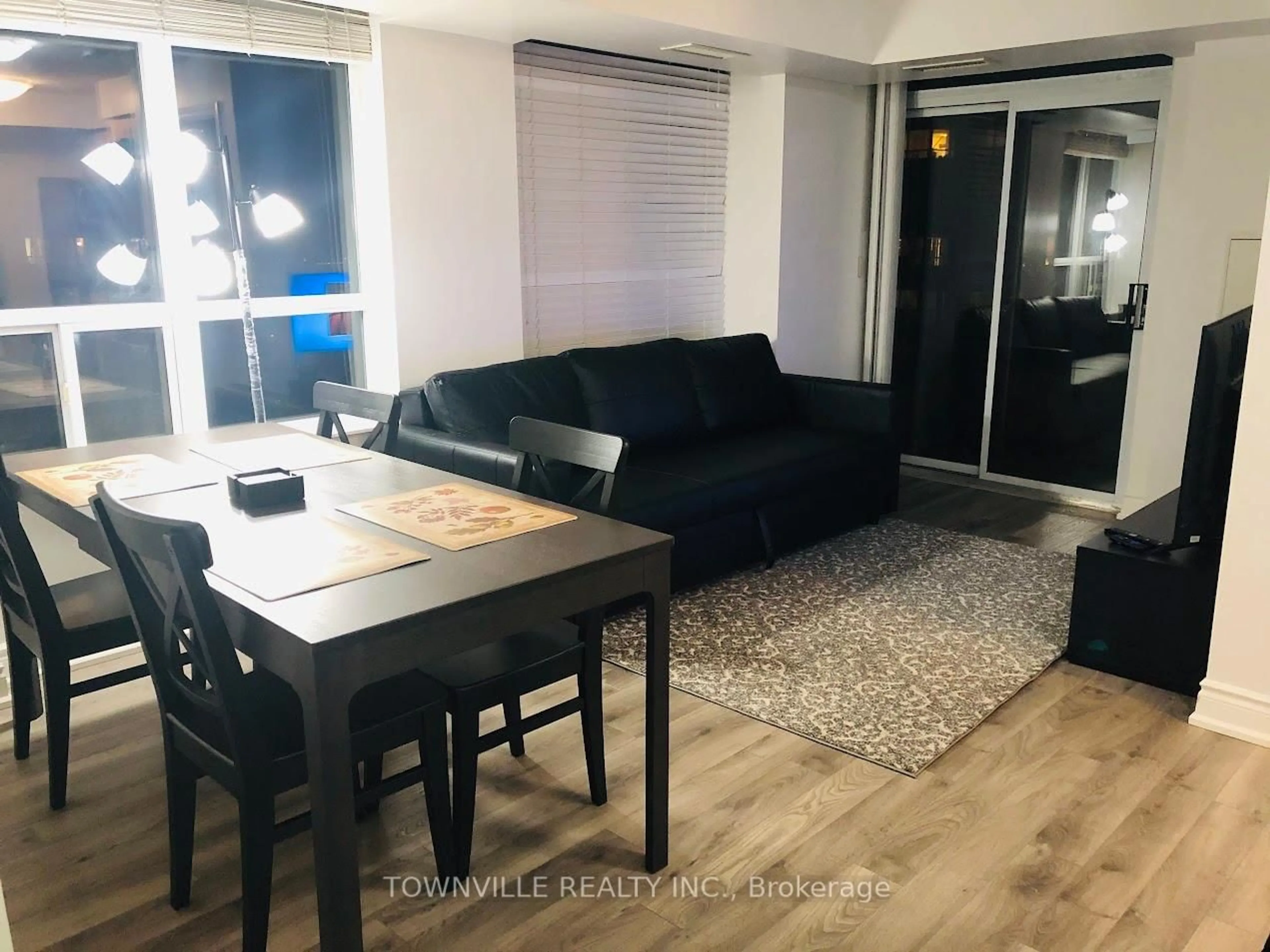 Living room with furniture, wood/laminate floor for 310 Burnhamthorpe Rd #1912, Mississauga Ontario L5B 4P9