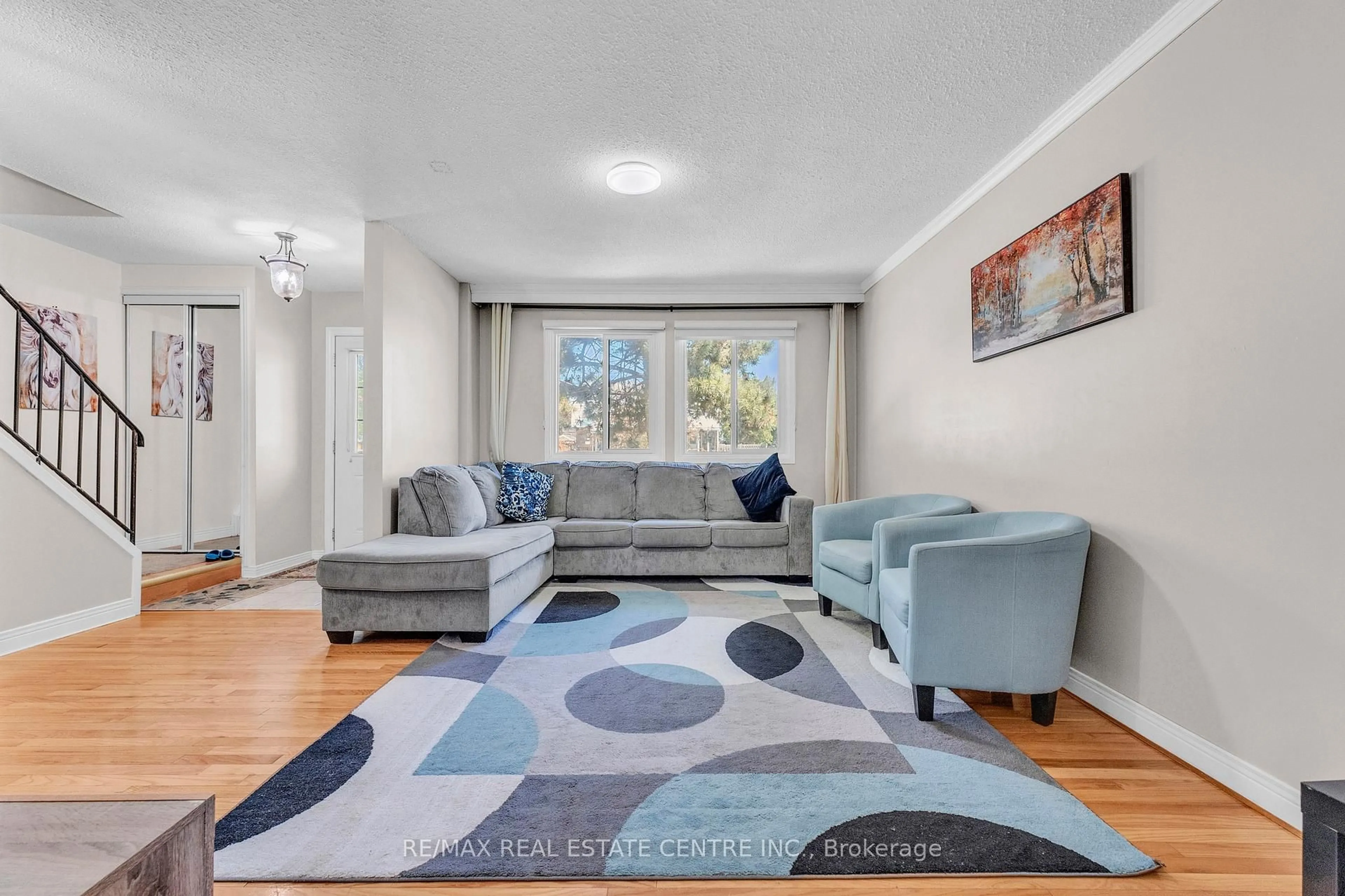 Living room with furniture, carpet floor for 105 Hansen Rd #102, Brampton Ontario L6V 3C9