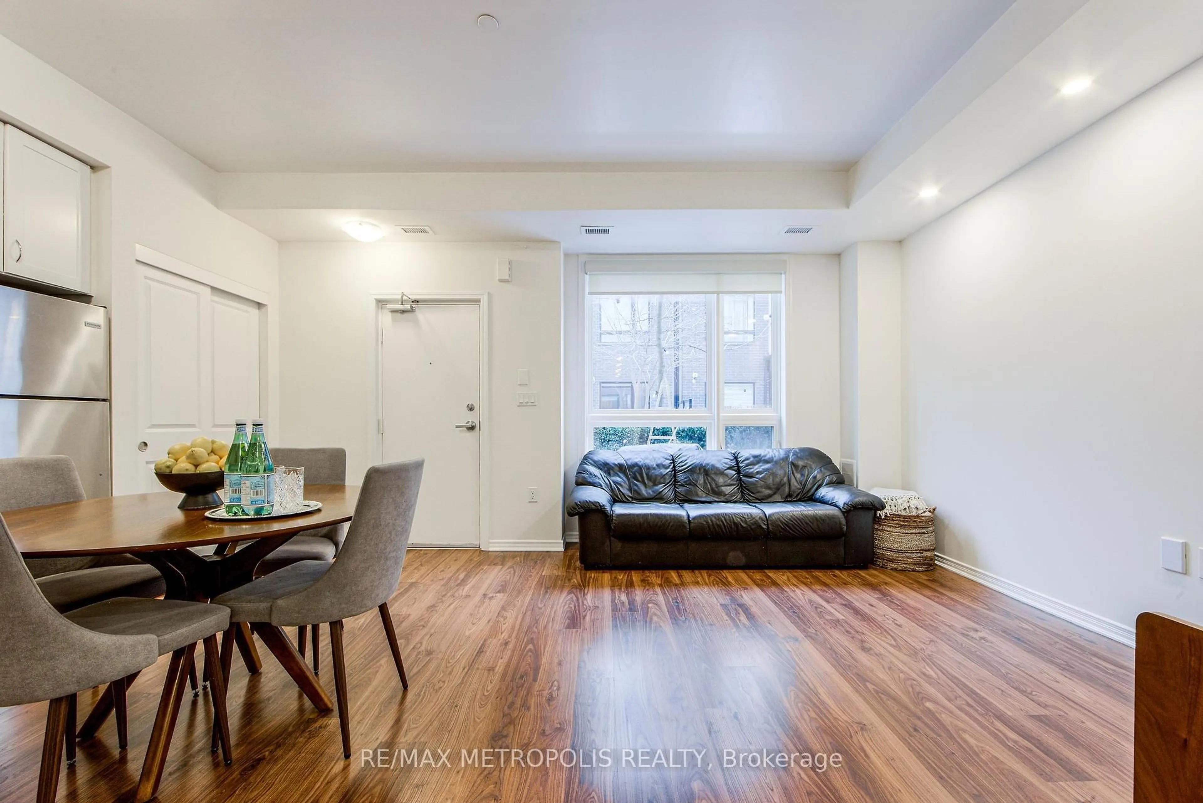 Living room with furniture, wood/laminate floor for 1130 Briar Hill Ave #106, Toronto Ontario M6B 0A9