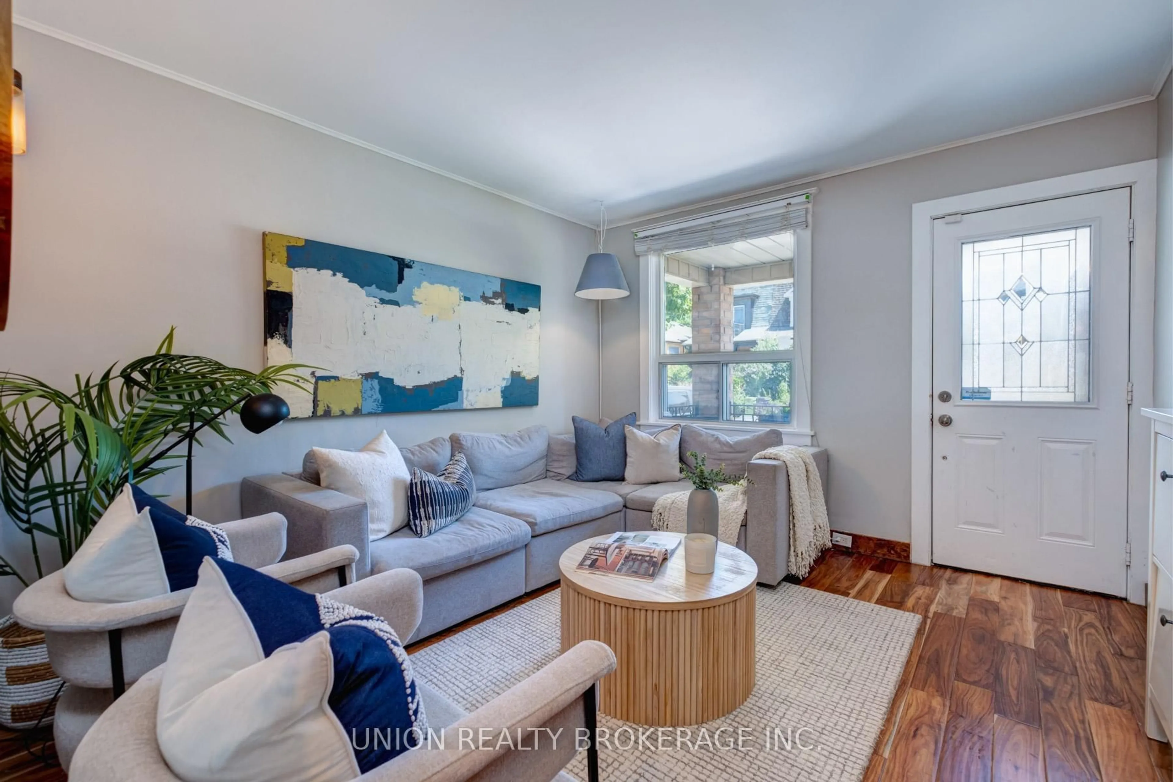 Living room with furniture, wood/laminate floor for 104 Blackthorn Ave, Toronto Ontario M6N 3H6