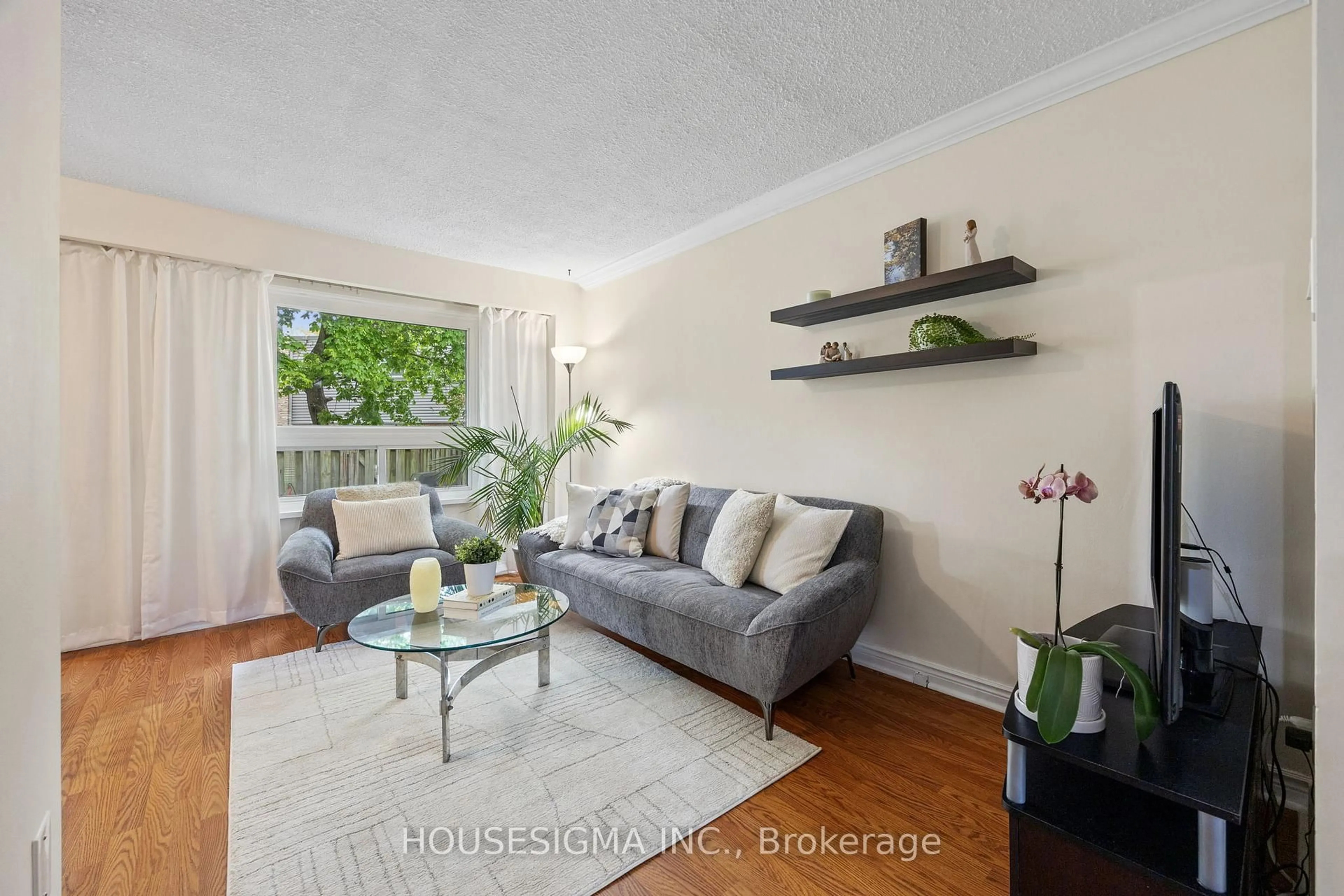 Living room with furniture, wood/laminate floor for 2315 Bromsgrove Rd #101, Mississauga Ontario L5J 4A6