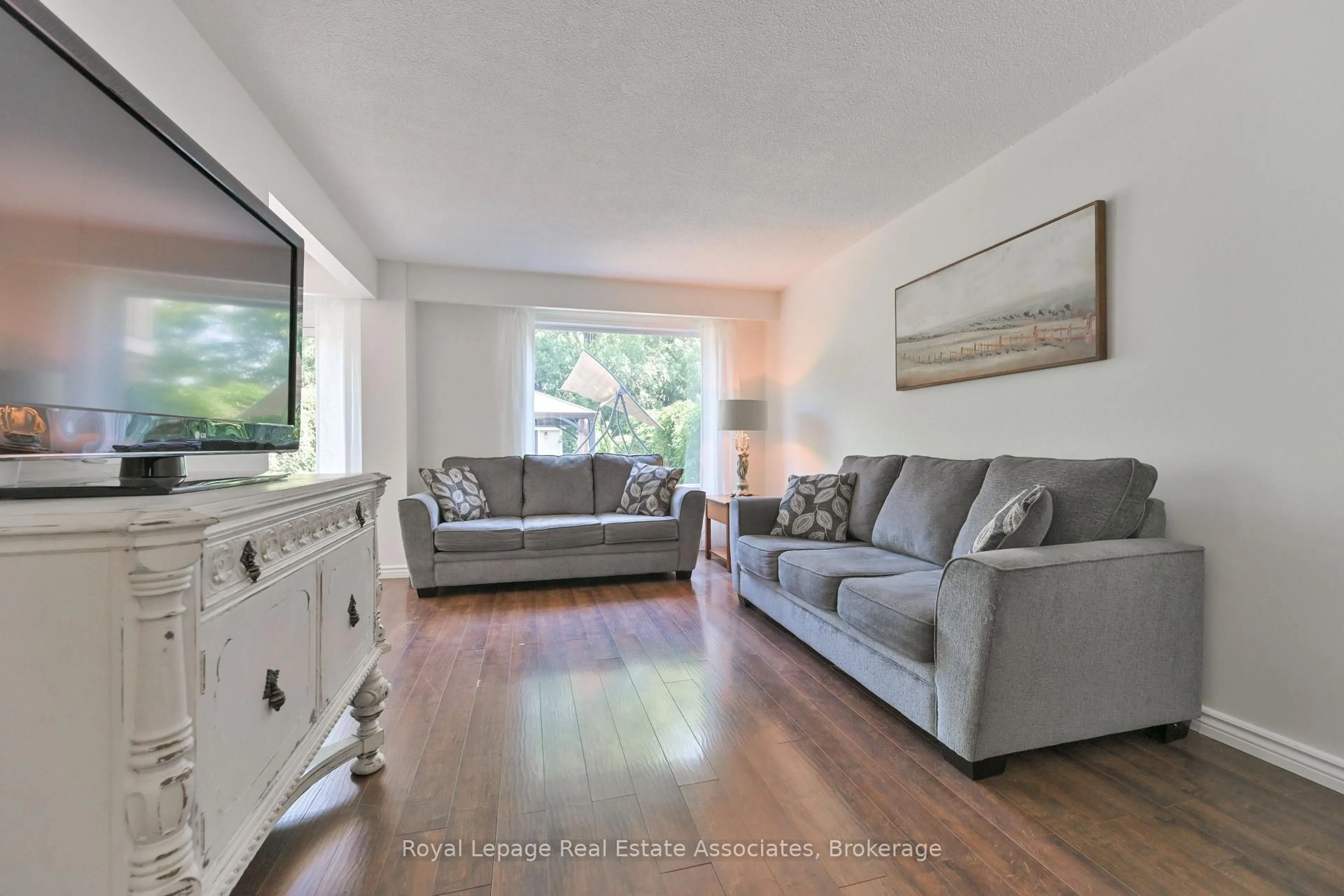 Living room with furniture, wood/laminate floor for 252 Royal Salisbury Way, Brampton Ontario L6V 3H4