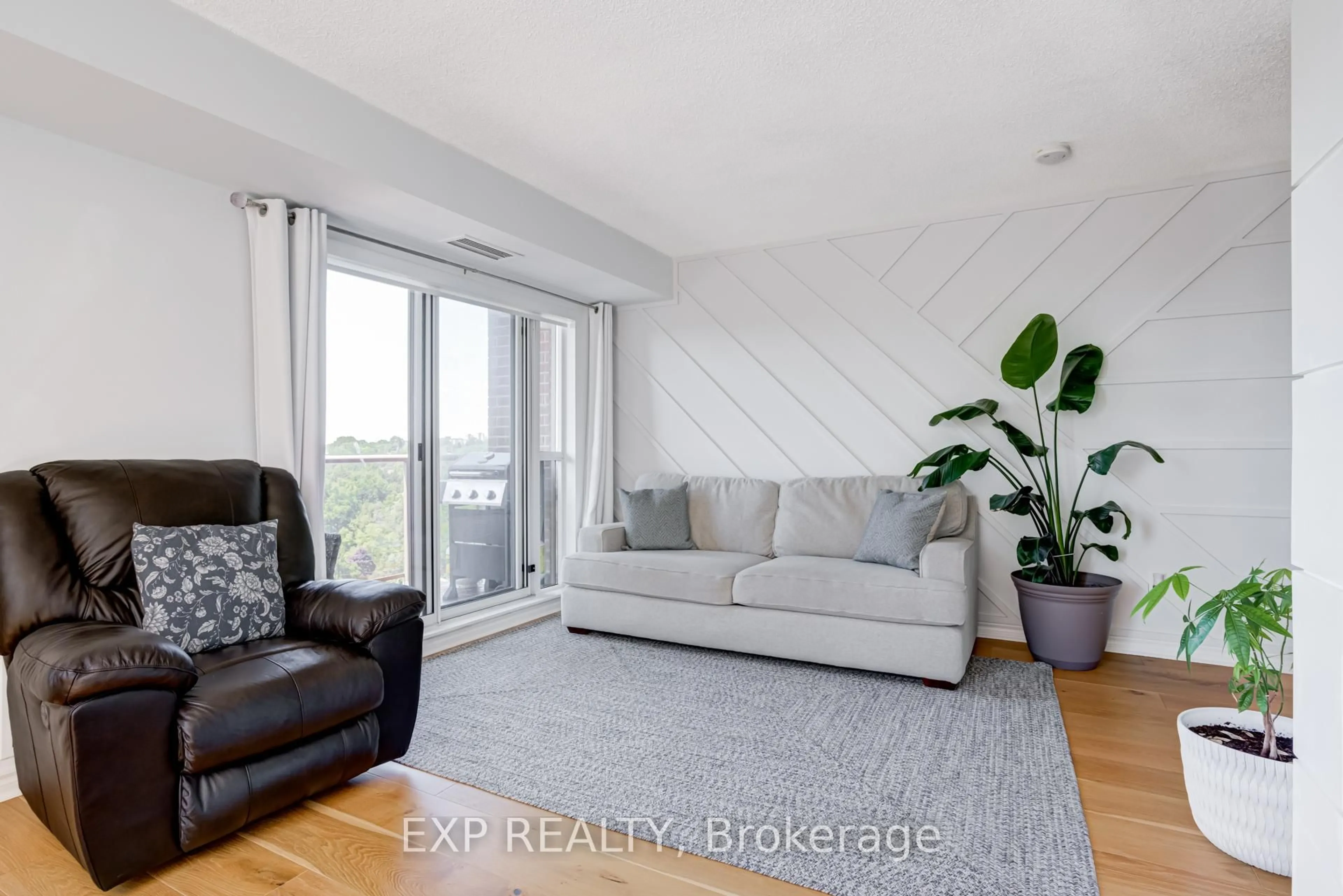 Living room with furniture, wood/laminate floor for 2088 Lawrence Ave #1002, Toronto Ontario M9N 3Z9