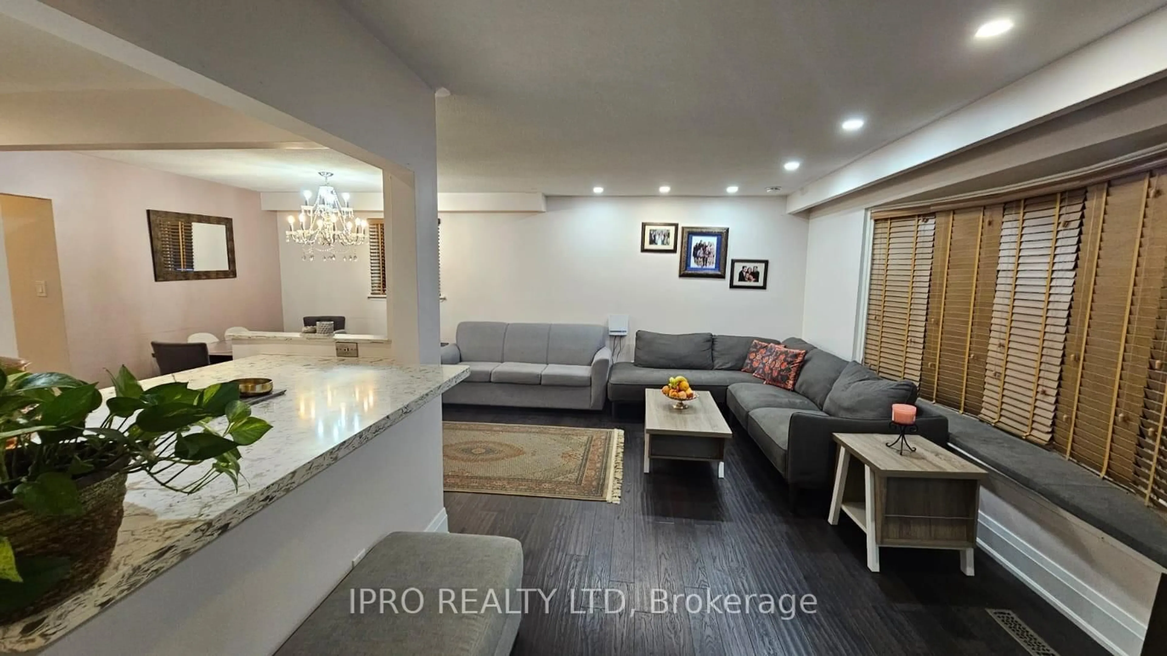 Living room with furniture, wood/laminate floor for 71 Grassington Cres, Brampton Ontario L6S 1Z5