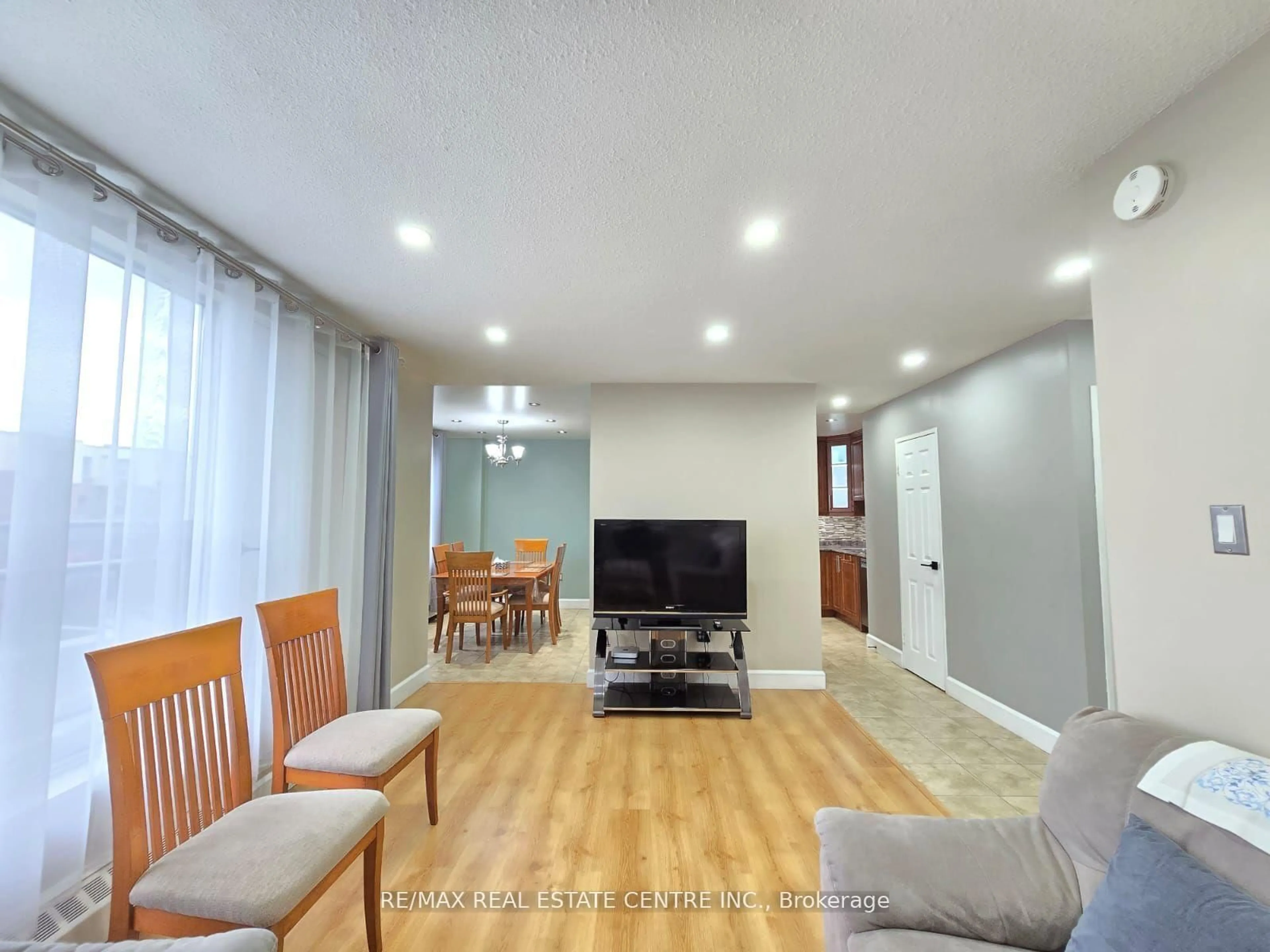 Living room with furniture, wood/laminate floor for 1055 A Forestwood Dr #212, Mississauga Ontario L5C 2T8