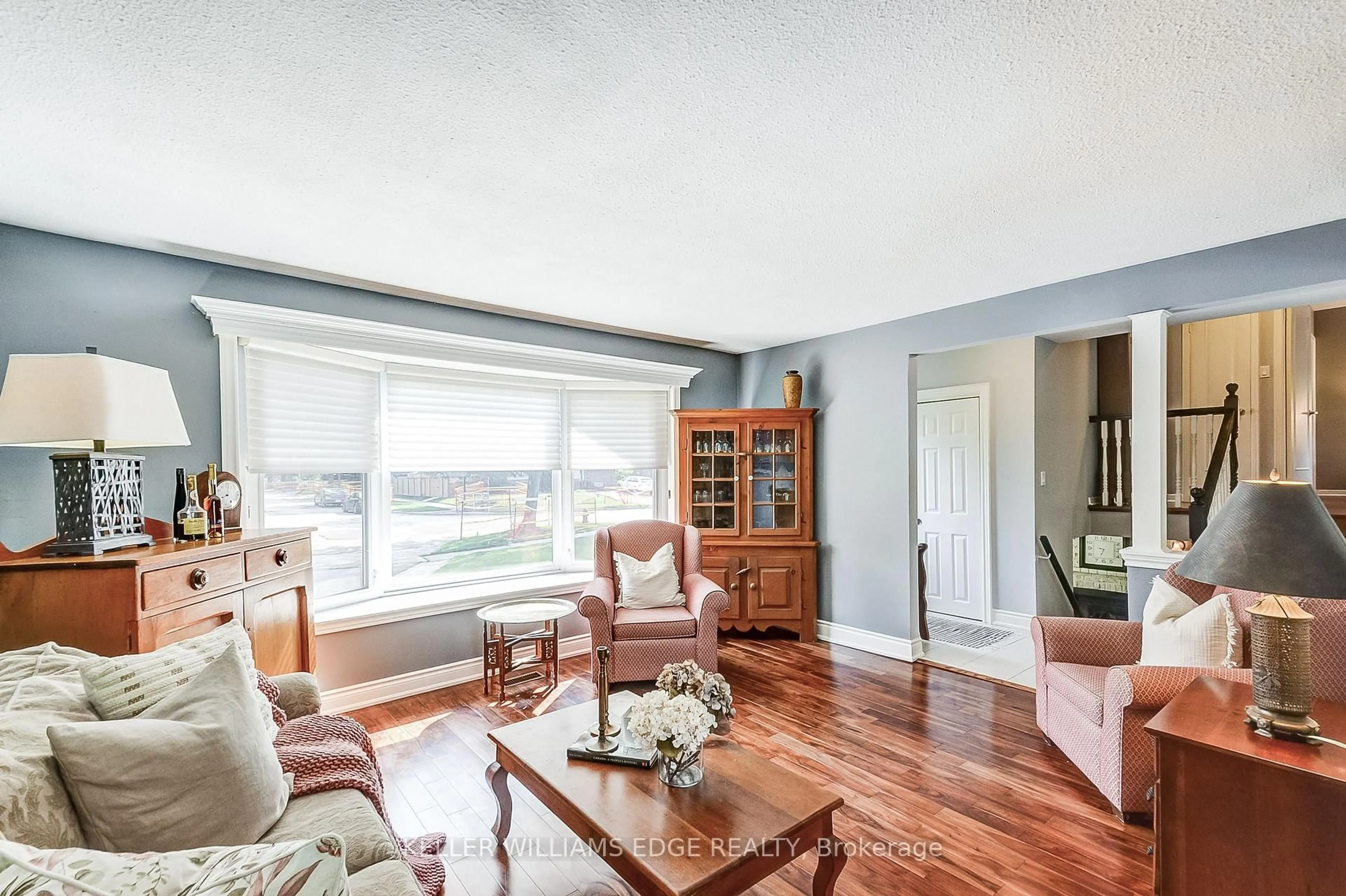 Living room with furniture, wood/laminate floor for 5203 Broughton Cres, Burlington Ontario L7L 3C1