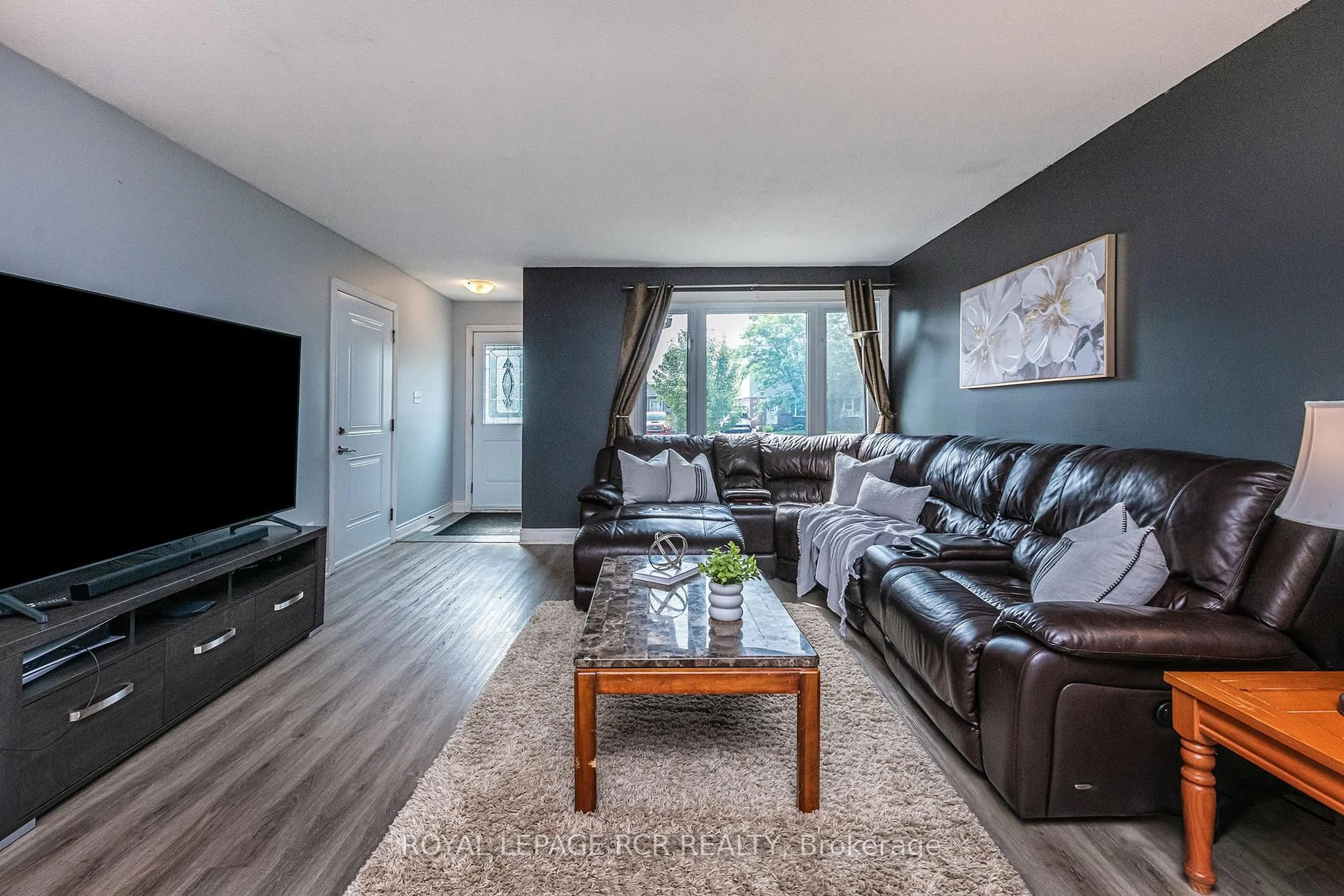 Living room with furniture, wood/laminate floor for 26 Feltre Ave, Orangeville Ontario L9W 3P1
