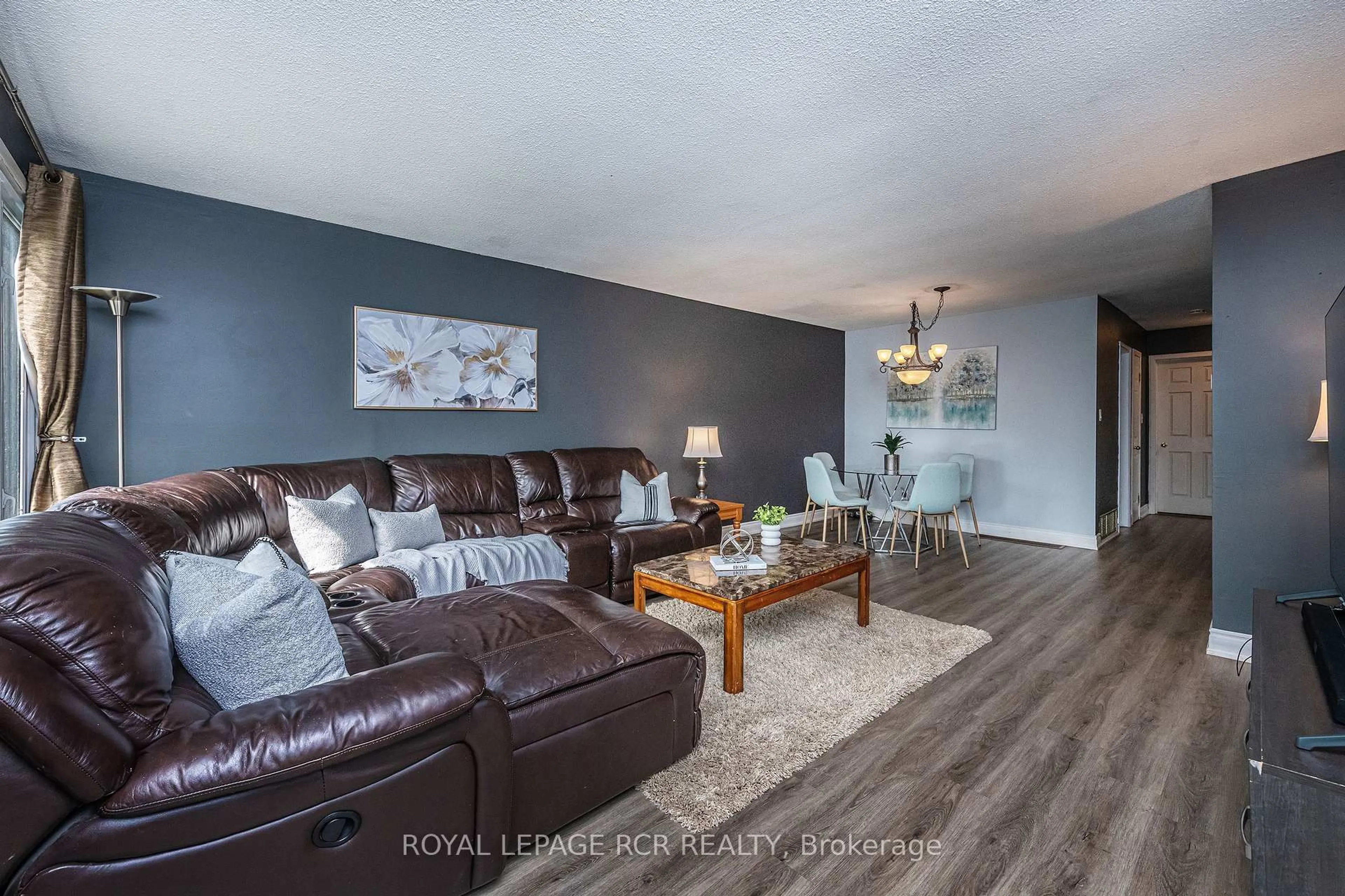 Living room with furniture, wood/laminate floor for 26 Feltre Ave, Orangeville Ontario L9W 3P1
