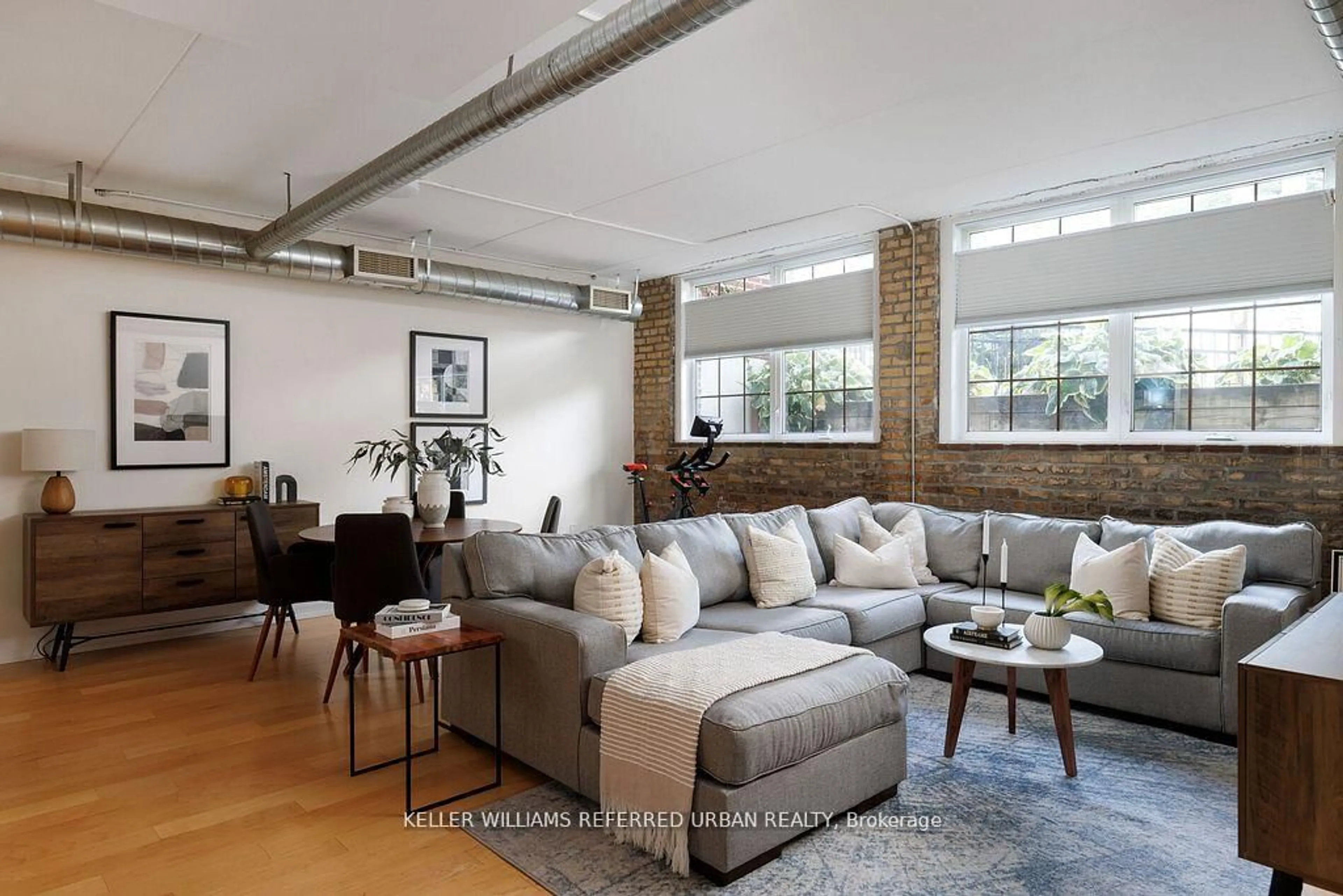 Living room with furniture, cement floor for 1100 Lansdowne Ave #A1, Toronto Ontario M6H 4K1