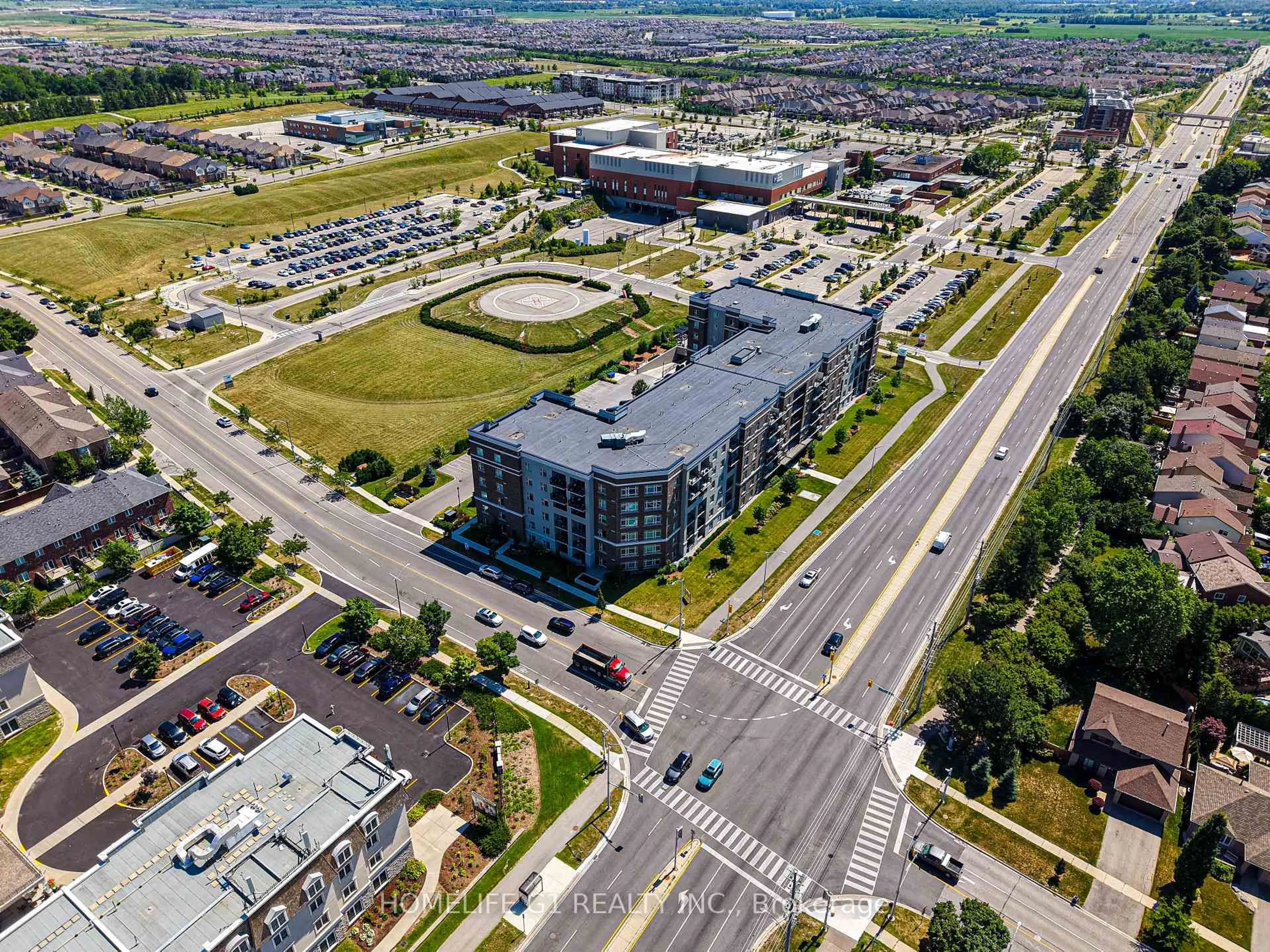 A pic from outside/outdoor area/front of a property/back of a property/a pic from drone, street for 610 Farmstead Dr #215, Milton Ontario L9T 8X5
