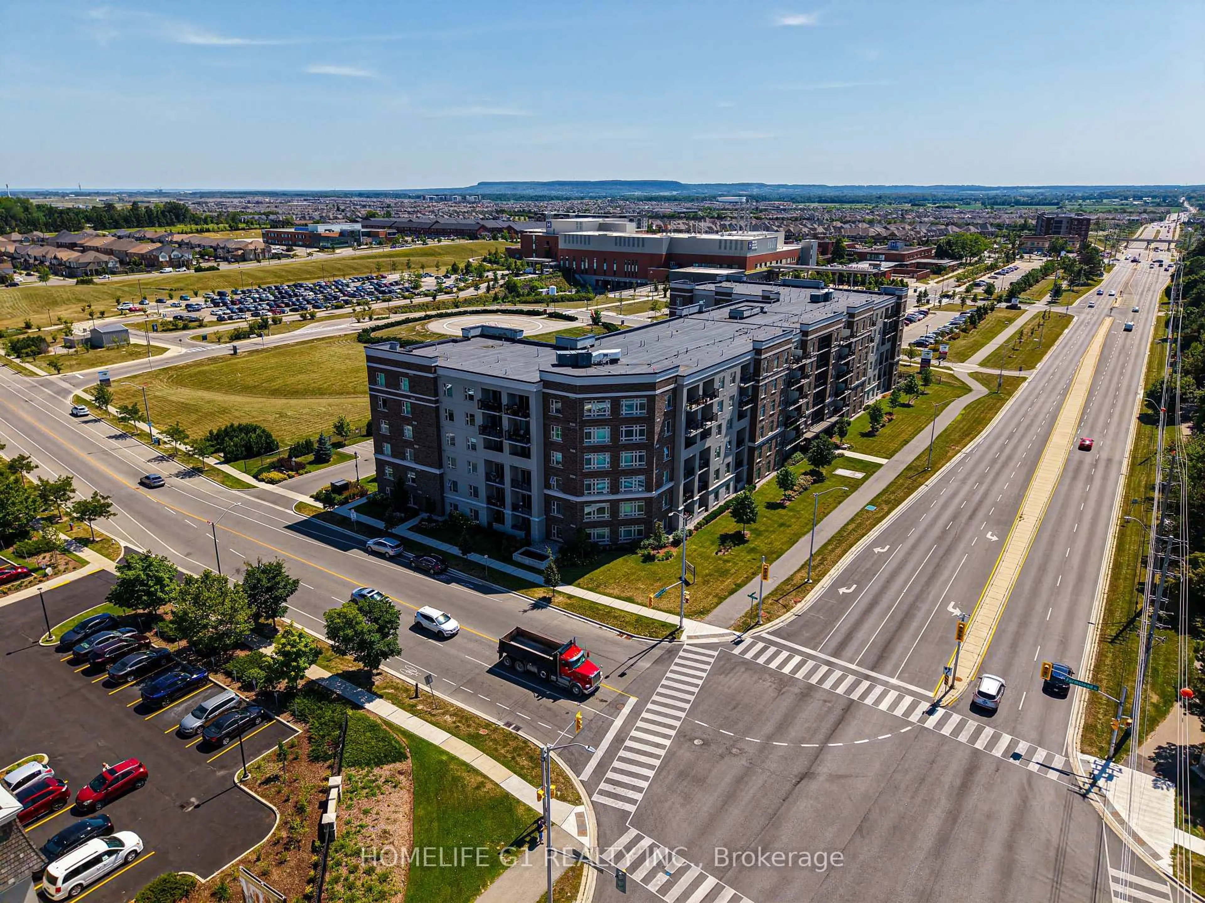 A pic from outside/outdoor area/front of a property/back of a property/a pic from drone, unknown for 610 Farmstead Dr #215, Milton Ontario L9T 8X5