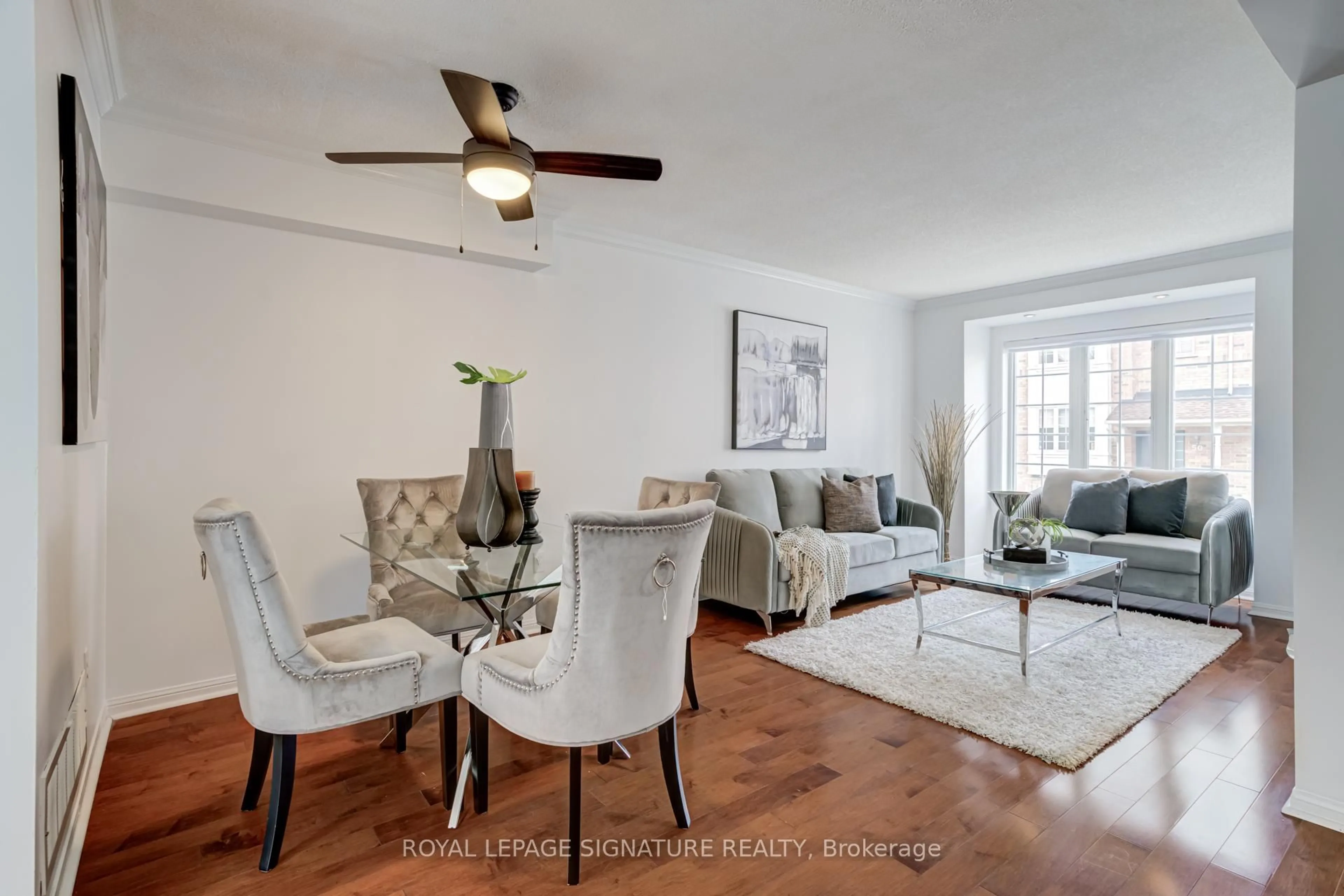 Living room with furniture, wood/laminate floor for 80 Acorn Pl #49, Mississauga Ontario L4Z 4E1